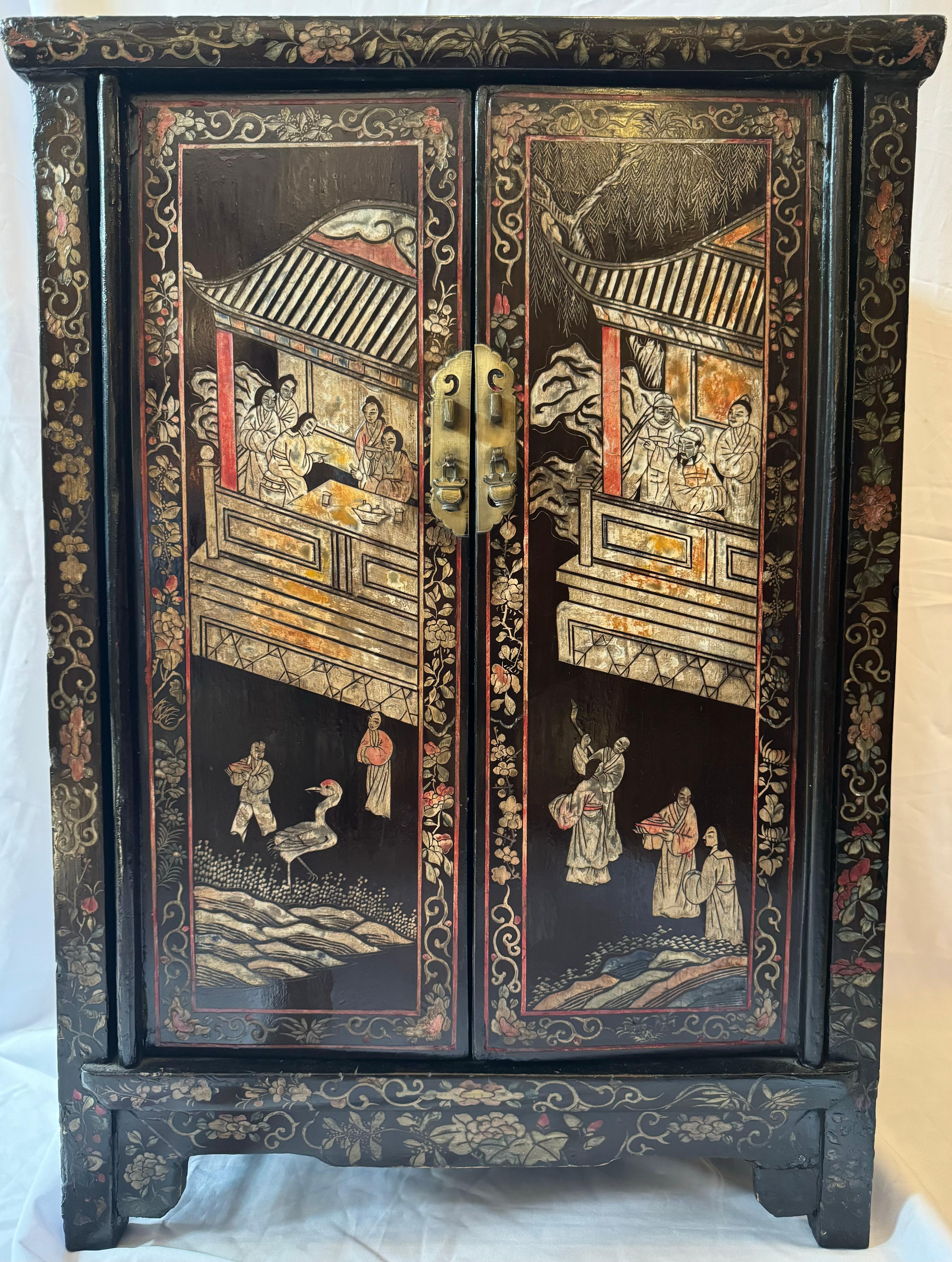 This 19th-century Chinese Chinoiserie lacquer side cabinet is a splendid testament to the enduring allure of the Chinoiserie movement that swept through Europe in the 17th century. As European fascination with Asian art and culture reached its