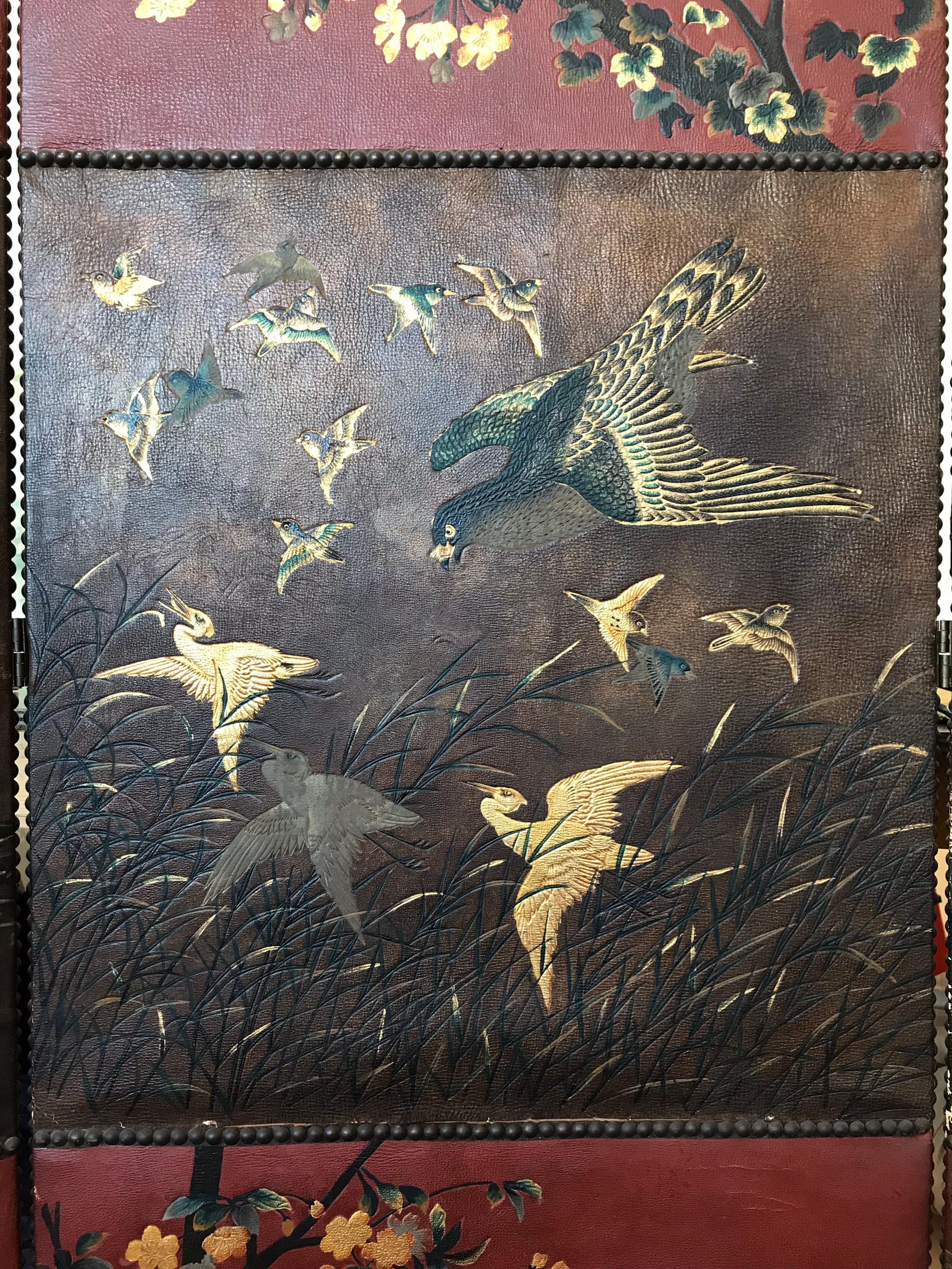 A beautiful leather three panel screen with nine separate sections of Japanese inspired designs of birds.

The back is fabric.