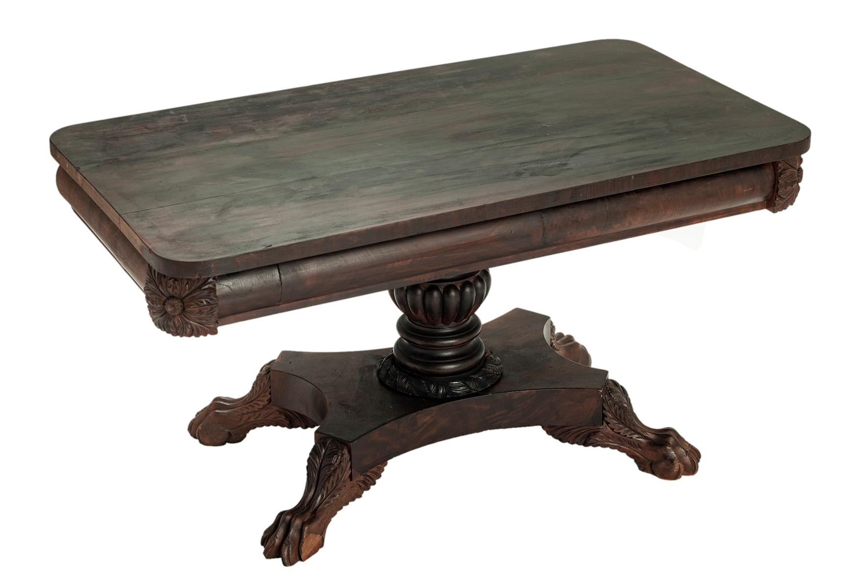 Early 19th Century chippendale coffee table converted from a game table. This antique handcrafted table is the perfect size for small spaces. Hand carved lion paw feet om a pedestal of dark mahogany with an ebony wash over dark reddish brown.