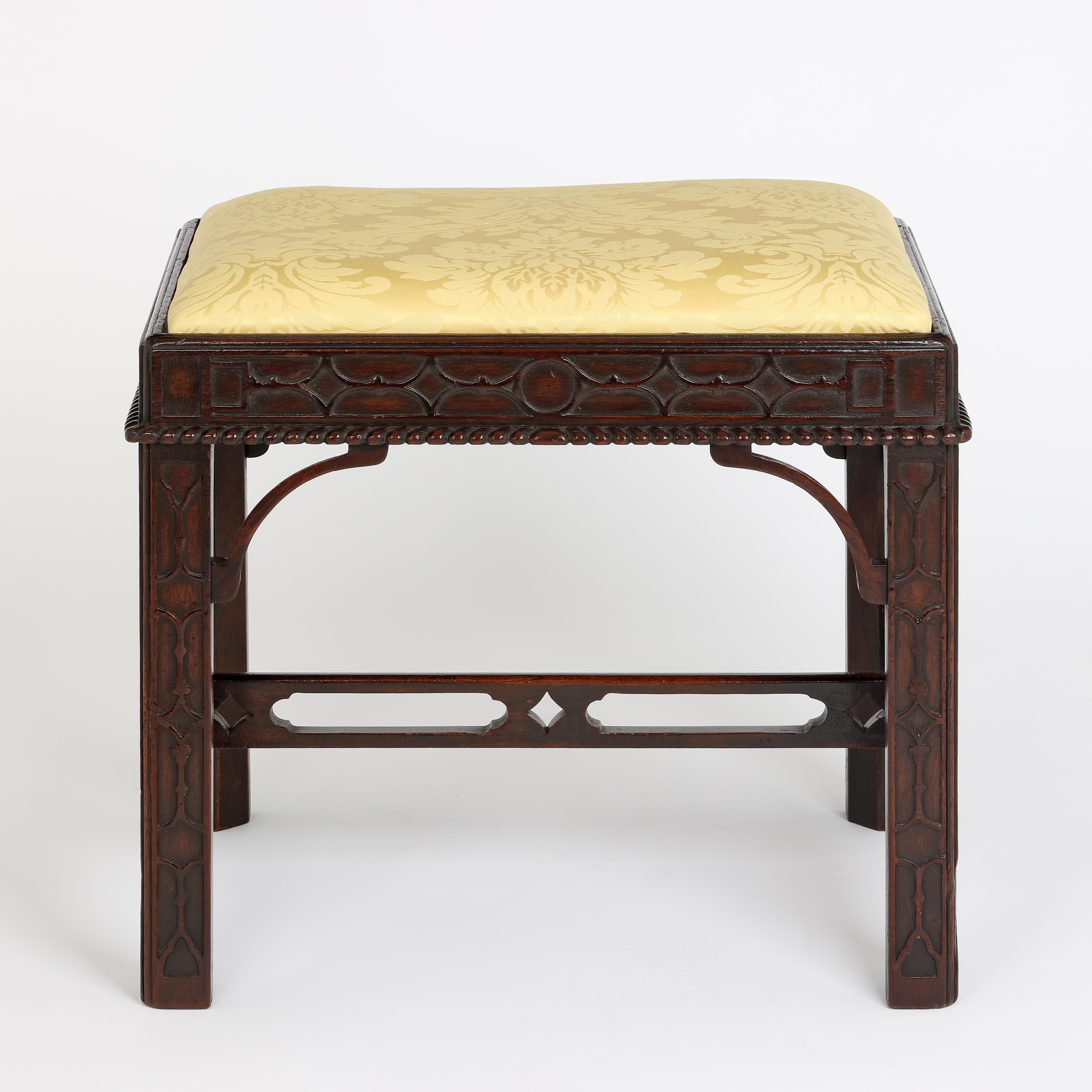 A fine quality 19th century mahogany rectangular stool the the Chinese Chippendale stlye with carved blind-fret carved decoration to the chamfered legs and frame, with gadrooned moulded edge and corner 'C'-scrolls.. The pierced 'H' stretchers below