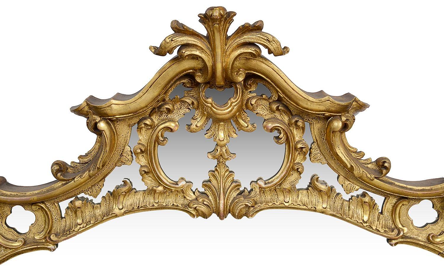 An ornate 19th Century Chippendale style carved giltwood and Gesso wall mirror, having wondeerful scrolling foliate, floral 'C' scroll decoration.

Batch 75 61031 UDNKZ