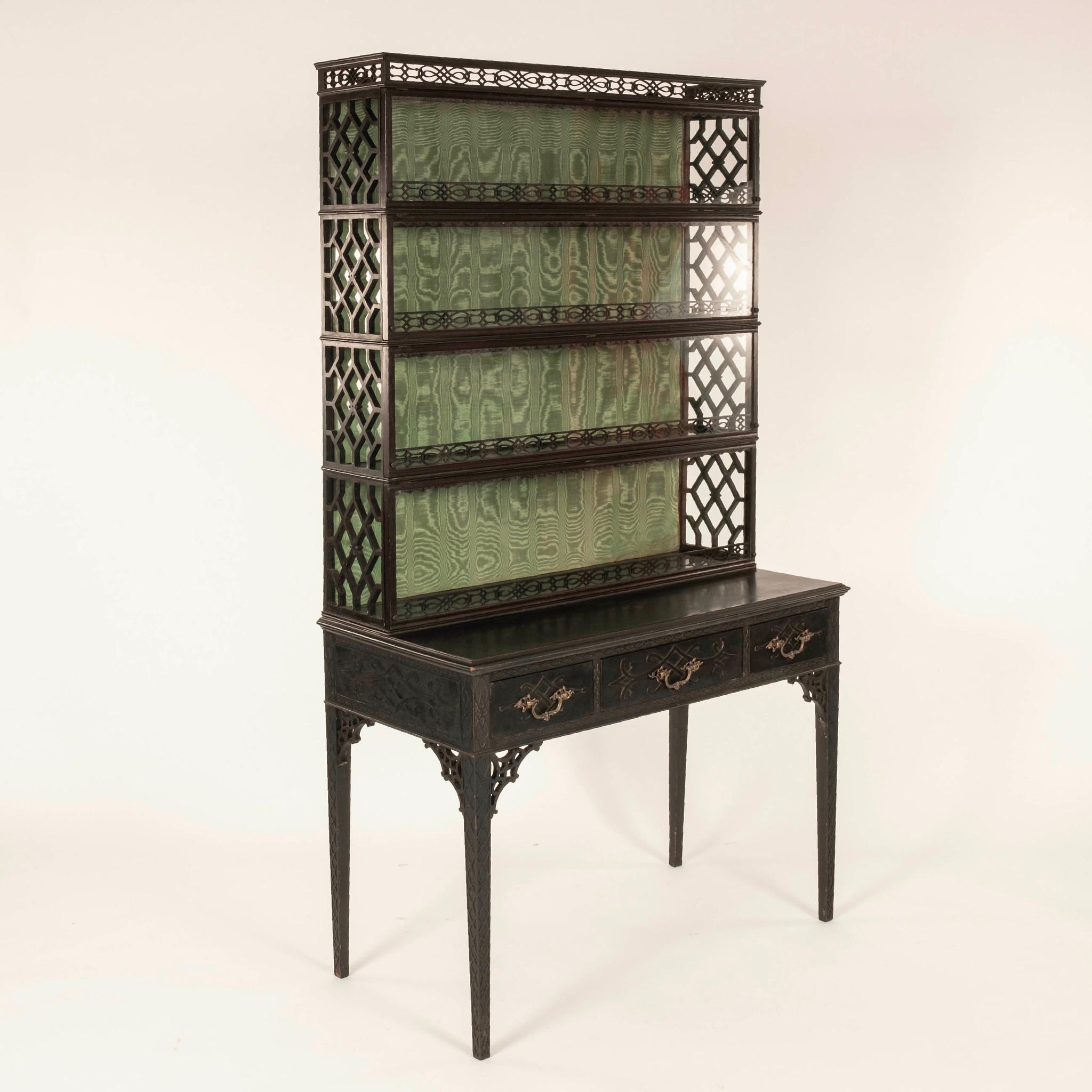 Lovely 19th Century Chippendale cabinet featuring wood fretwork, gallery top, four glass lift up doors, three drawers and Verde green silk moire lined inside back.

Visit our other 1STDIBS storefront Moxie Interiors to shop a vast array of
