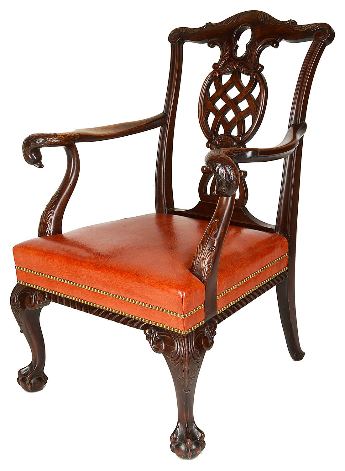 A very good quality 19th century mahogany Chippendale style armchair, having a carved and fretted back splat, carved scrolling swans heads to the arms, hide upholstered seat and raised on scrolling cabriole legs, terminating in ball and claw feet.