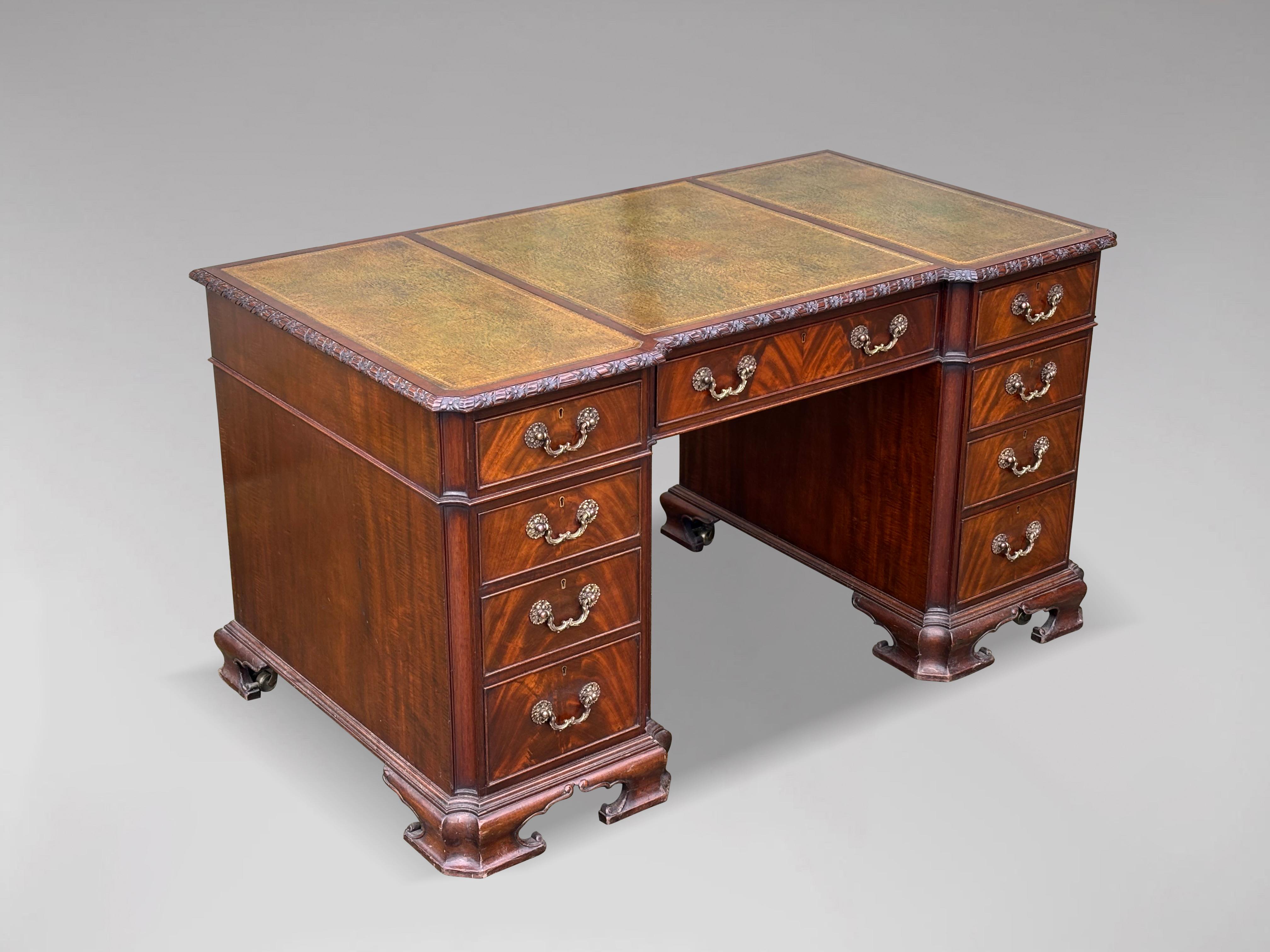 A very fine 19th century Chippendale style mahogany pedestal desk. The rectangular top with inset green tooled leather writing surface and carved moulded edge, above three frieze drawers. The twin pedestals fitted with three graduated drawers. The