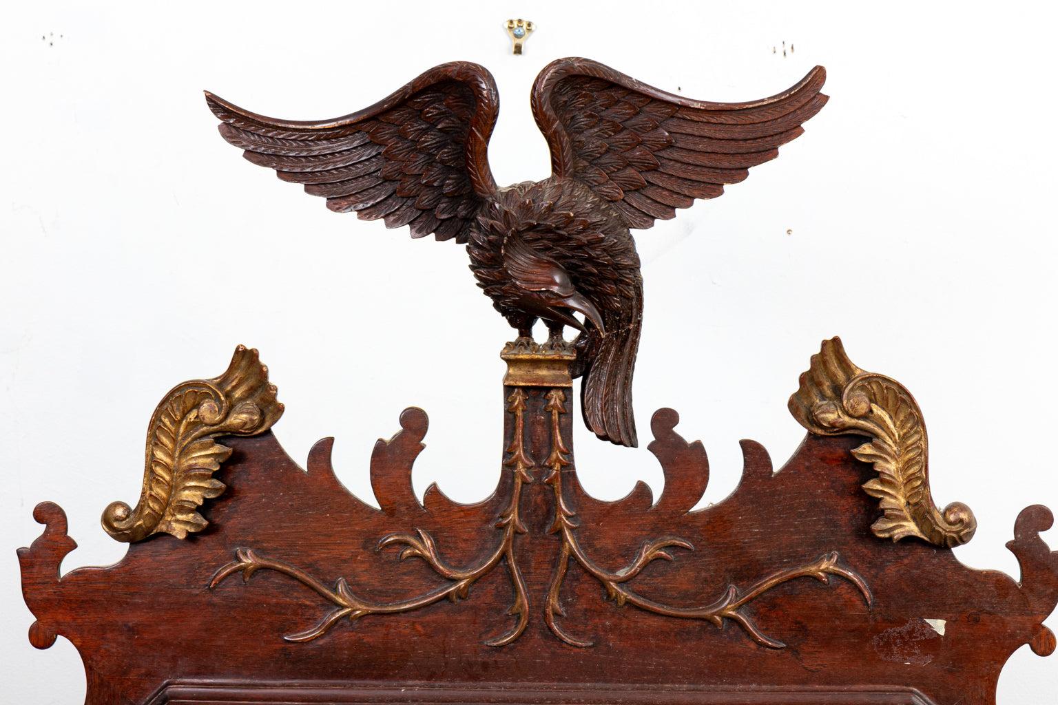 A 19th century American Chippendale style mirror with carved spread wing eagle crest. Gilt acanthus and and applique decoration. Wear consistent with age.