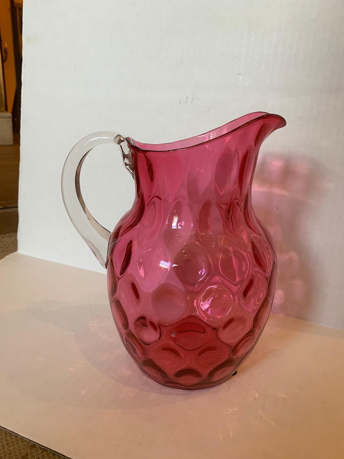 19th century circa 1880 cranberry glass thumbprint pattern water pitcher with applied clear handle, possibly Fenton.