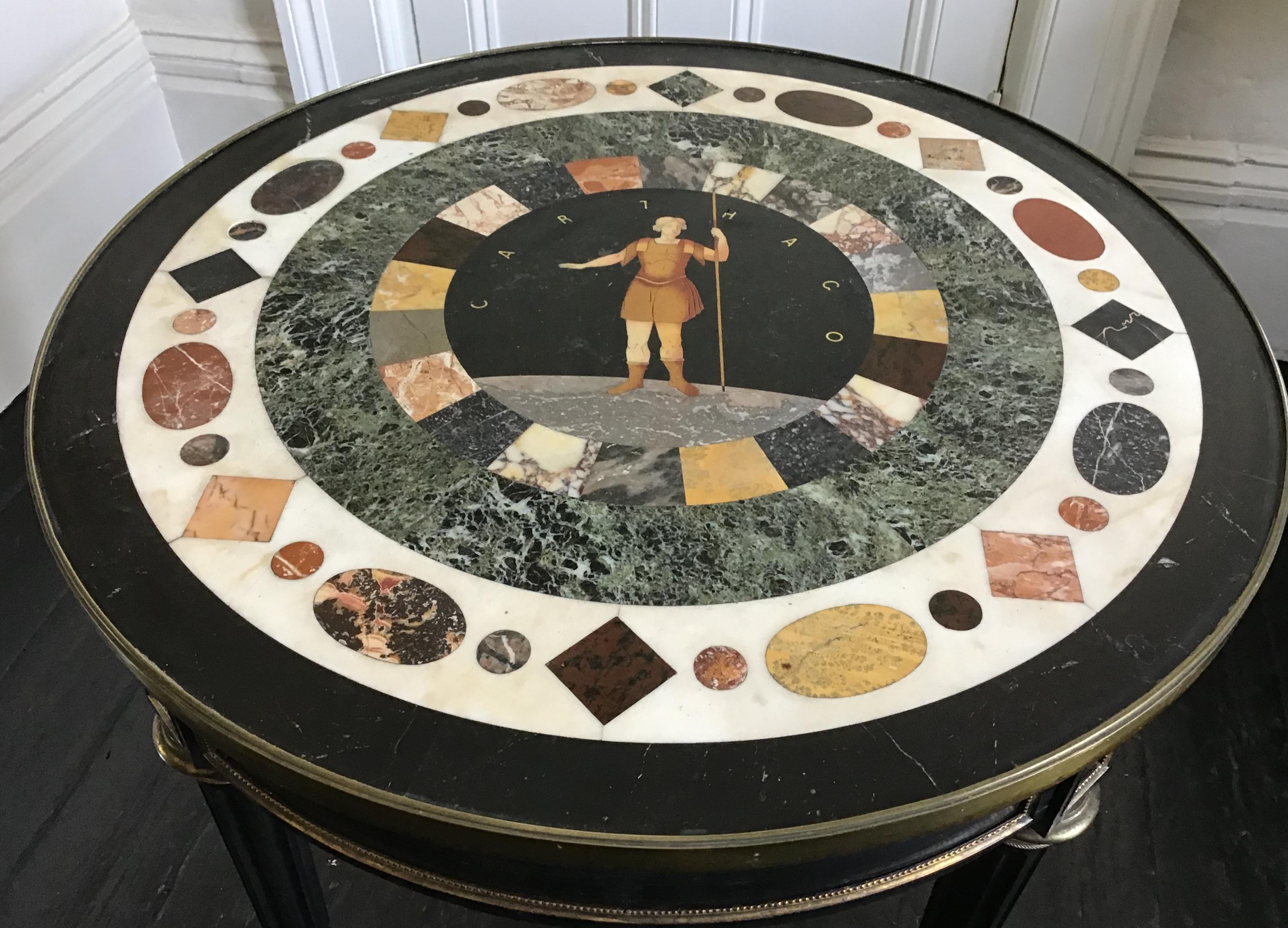 19th century English circular ebonized and gilt metal mounted with circular Italian specimen marble top depicting a classical figure and inscribed “CARTHAGO”The top made up of concentric rings of black green and the specimen marble inset ring the