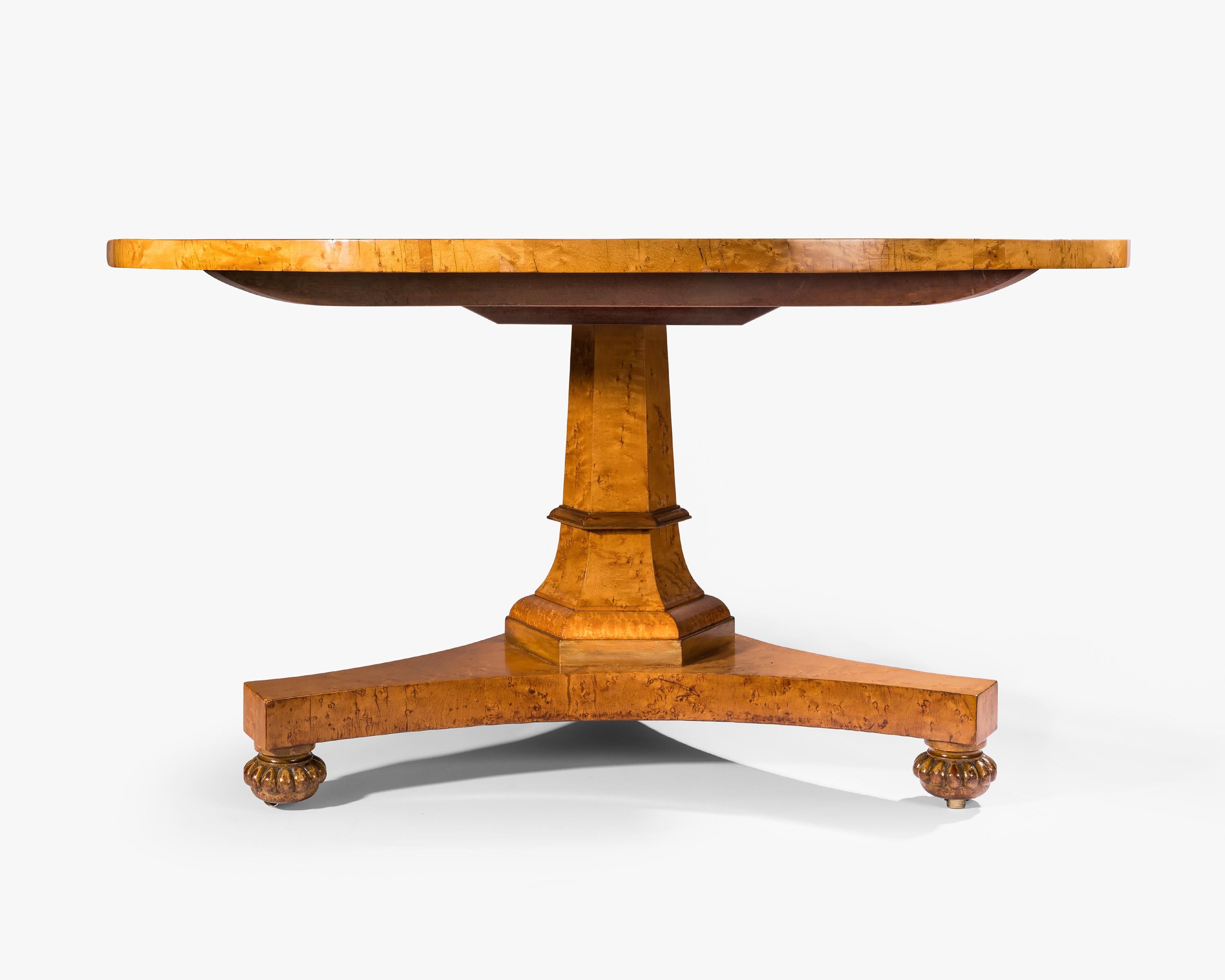 A large circular tilt-top burr maplewood veneered centre table. The burr maplewood is laid on solid mahogany which is an excellent sign of quality.
On the large block is the stamp of 'GILLOWS'. The faceted column and reeded feet are parcel gilded.