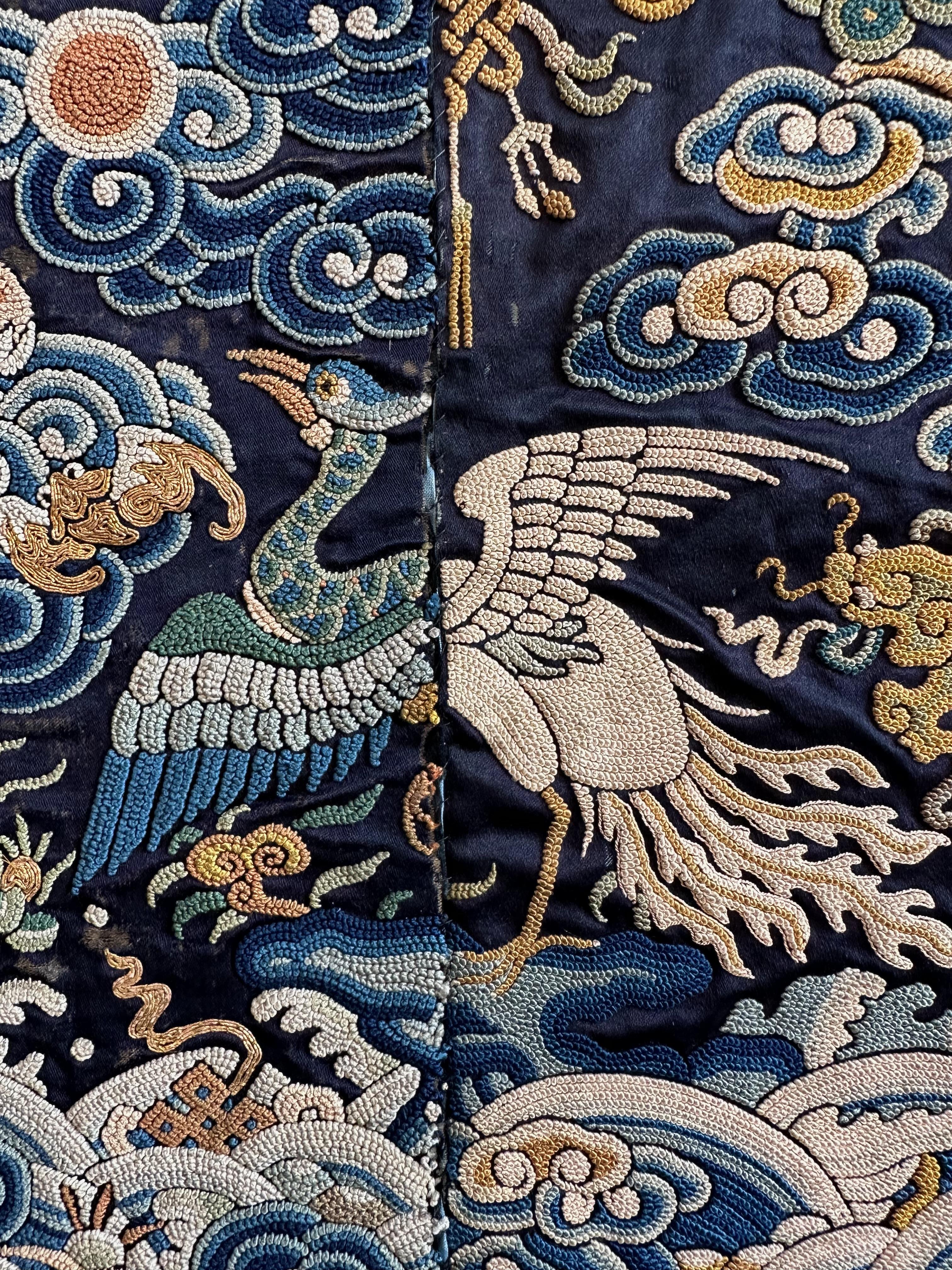 Qing Dynasty silk embroidery civil rank badge with silver pheasant combined with peacock, 19th century.

This badge is a hybrid, made up of the front half of a peacock badge sewn together with the back half of a silver pheasant. The peacock can be