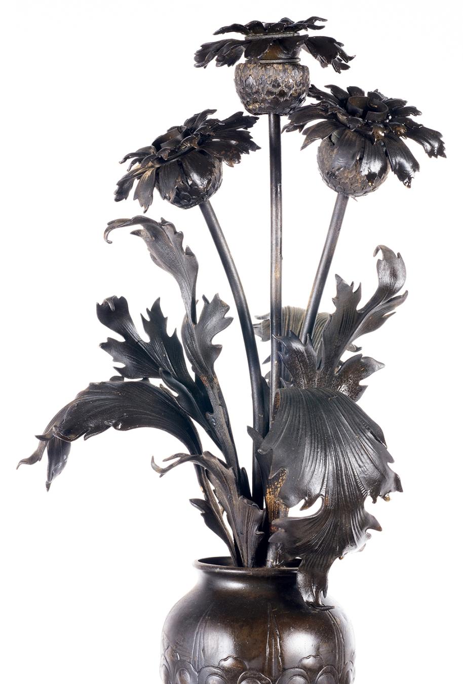 An enchanting 19th Century bronze lamp, with a semi clad putti holding up a classical vase of flowers.

 