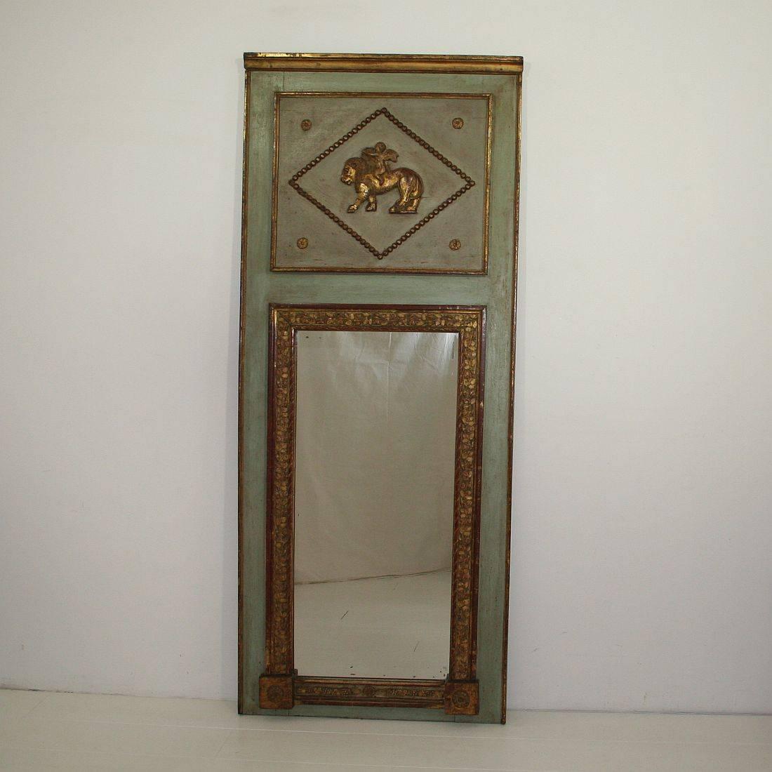 Great classical trumeau mirror with gilded cupid on a lion, France, 19th century. Weathered, old repairs. Wooden frame with chalk/terracotta ornaments.