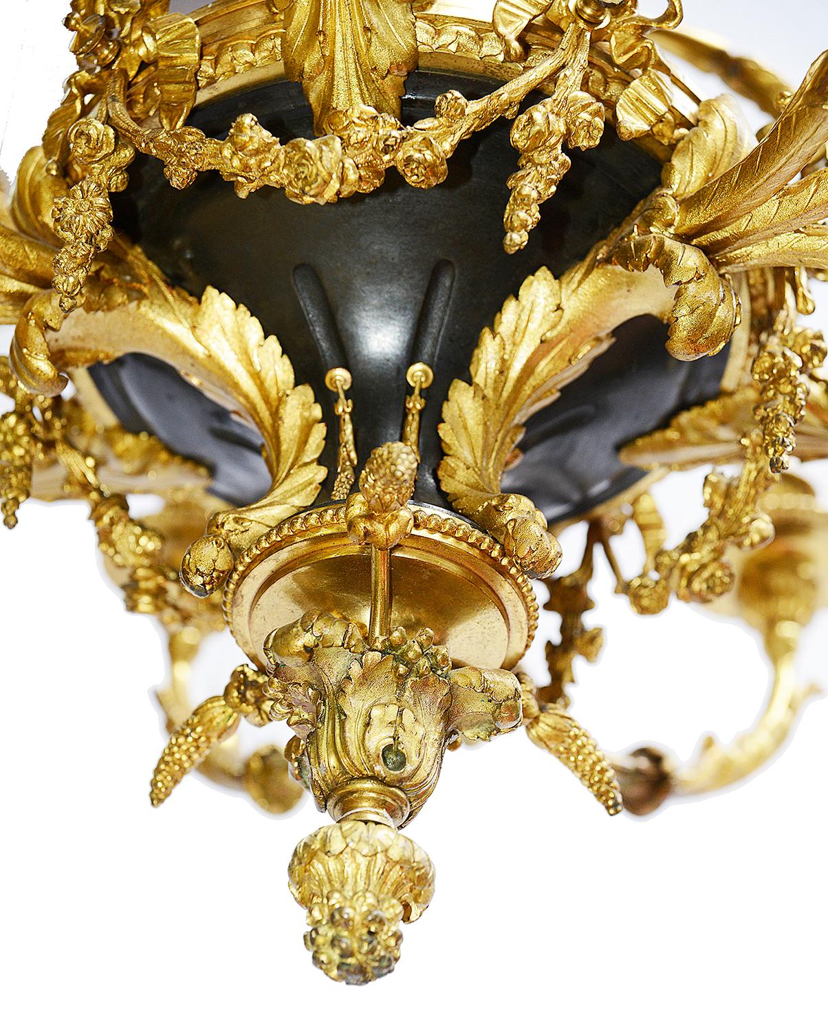 A very impressive late 19th century classical Louis XVI style ormolu and bronze 15 branch chandelier, having scrolling foliate, floral and ribbon swags, winged cherubs supports sconces.