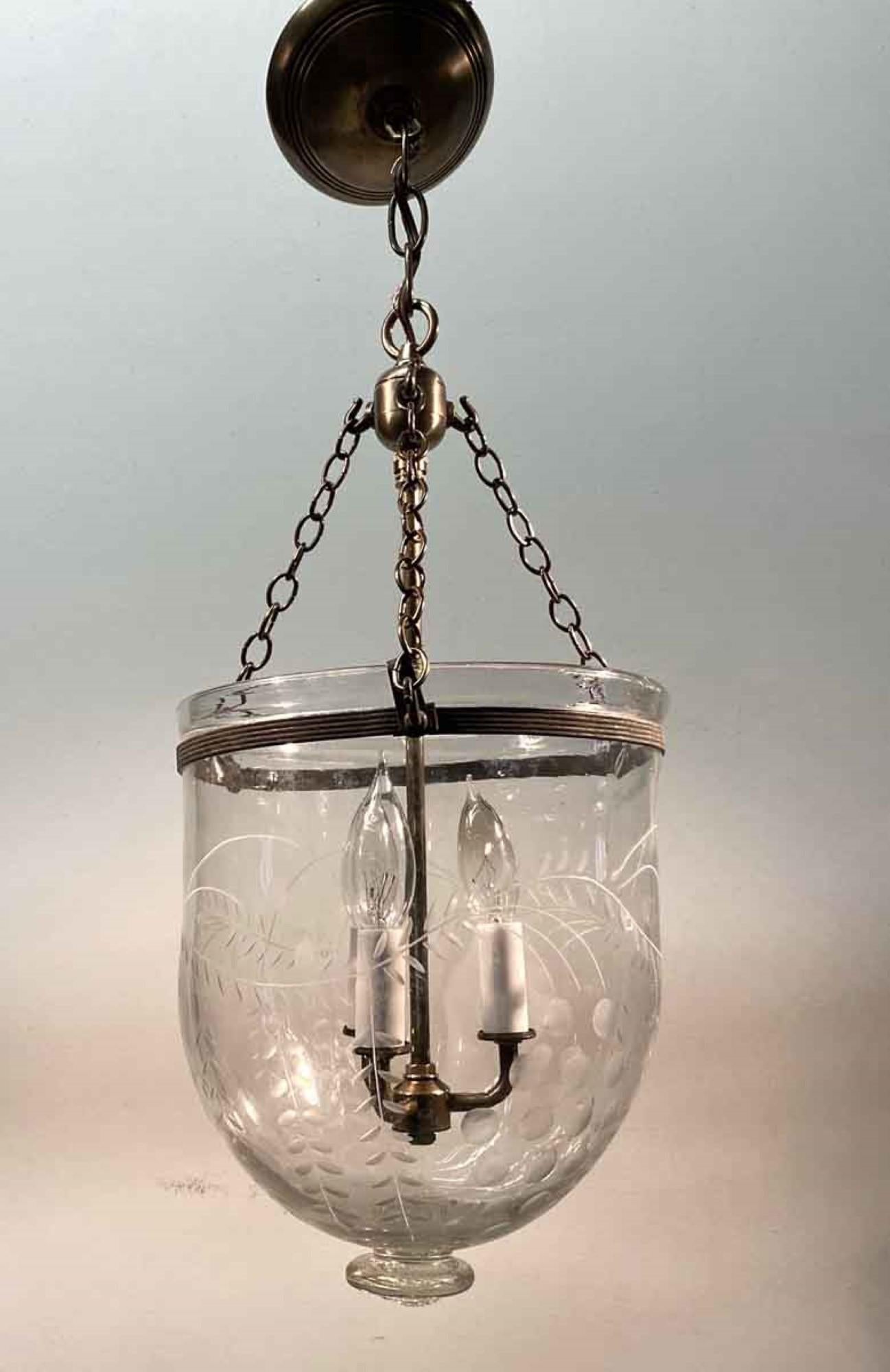 19th century hand blown glass bell jar pendant lantern from England with etched details and new brass hardware. Features three candelabra lights. This can be seen at our 400 Gilligan St location in Scranton. PA.