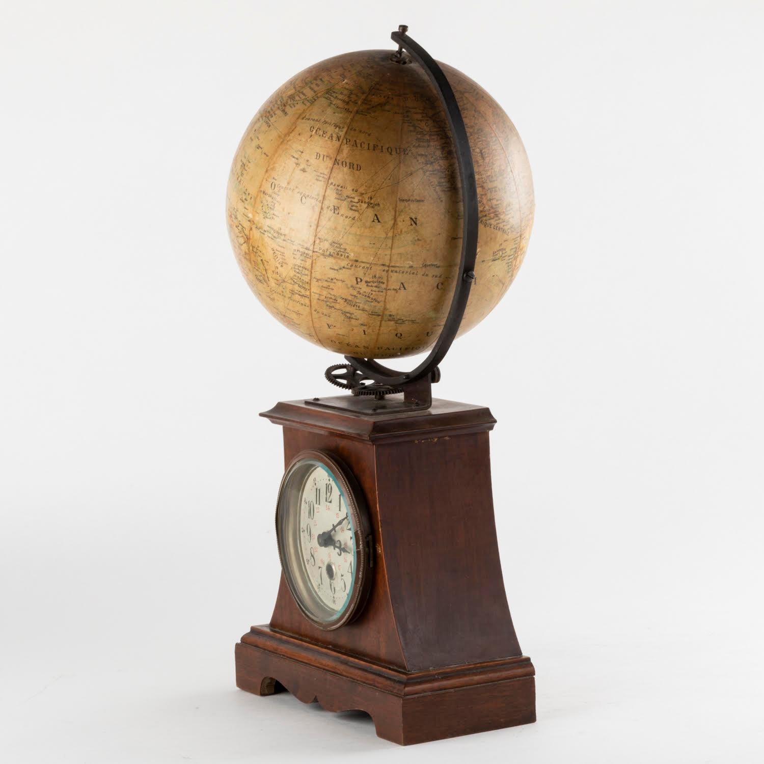 19th century clock surmounted by a globe, Napoleon III period.

19th century clock, Napoleon III period, surmounted by a terrestrial globe, clock movement to be revised, does not work.
H: 42cm, W: 22cm, D: 17cm