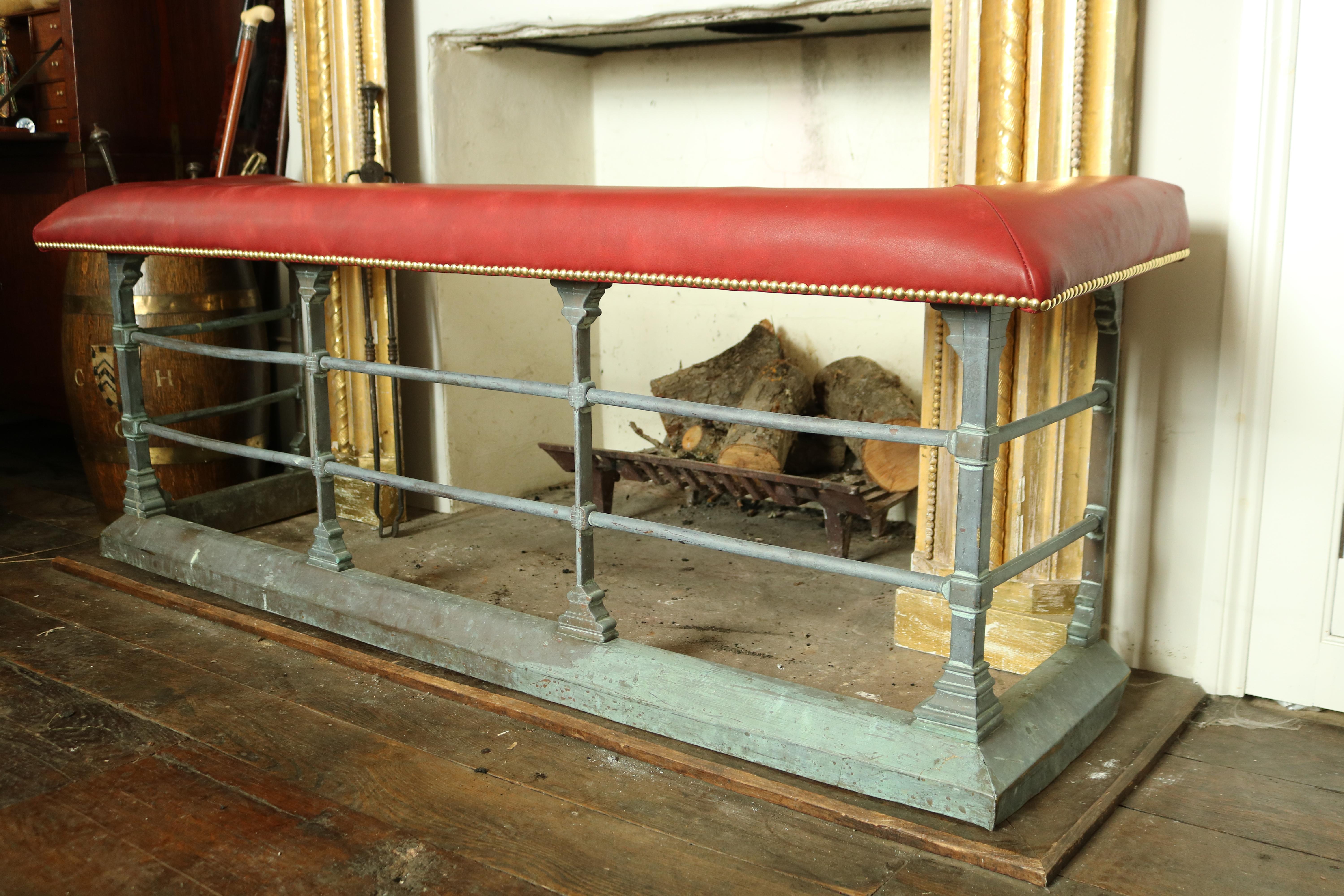 A handsome late 19th century brass fire side club fender with leather padded seat, the brass section of the fender has aged to a beautiful verdigris patina and the red leather top has been recently re-upholstered to a high standard.

Inner