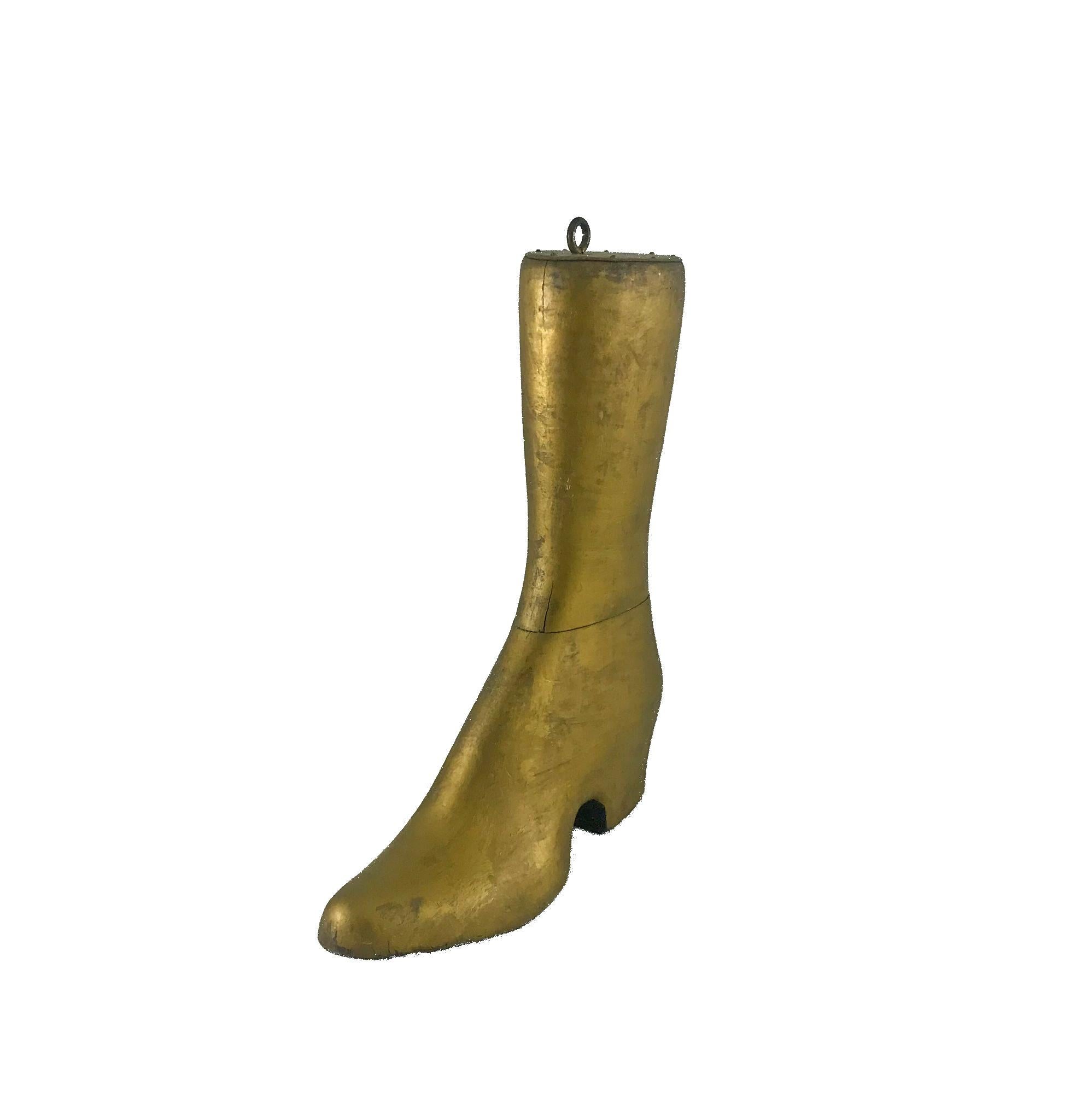 A carved cobbler's boot-form trade sign, in old gold paint.
Carved in two pieces of pine, capped with lead,
circa 1870
Very good condition, measures: 14