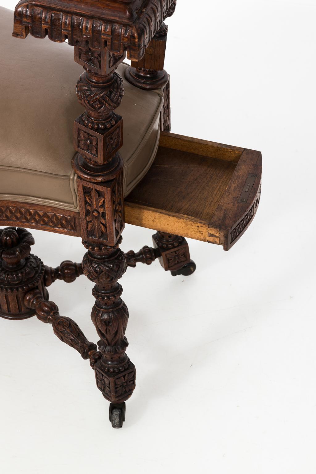 19th century walnut cockfighting chair with leather upholstery, and hidden storage compartment.