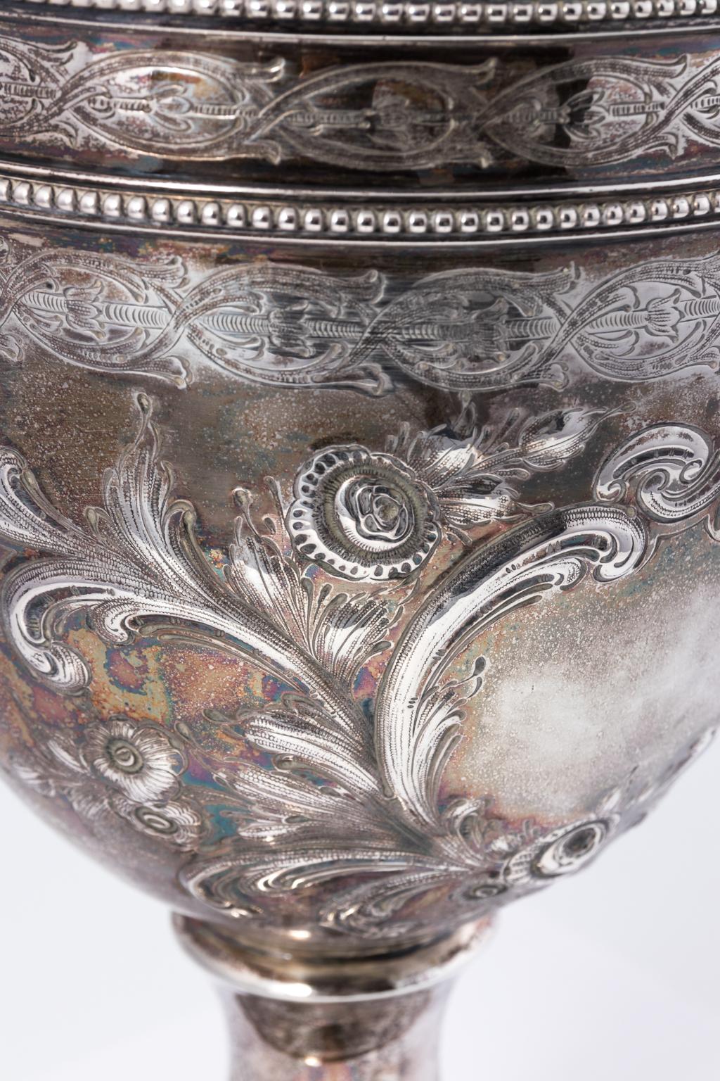 Unsigned but tested coin silver pitcher in the Rococo Revival style that features beaded trim and is hand chased with intricate scrolled foliate designs, circa mid-19th century. The pitcher weighs 30.915 troy ounces.