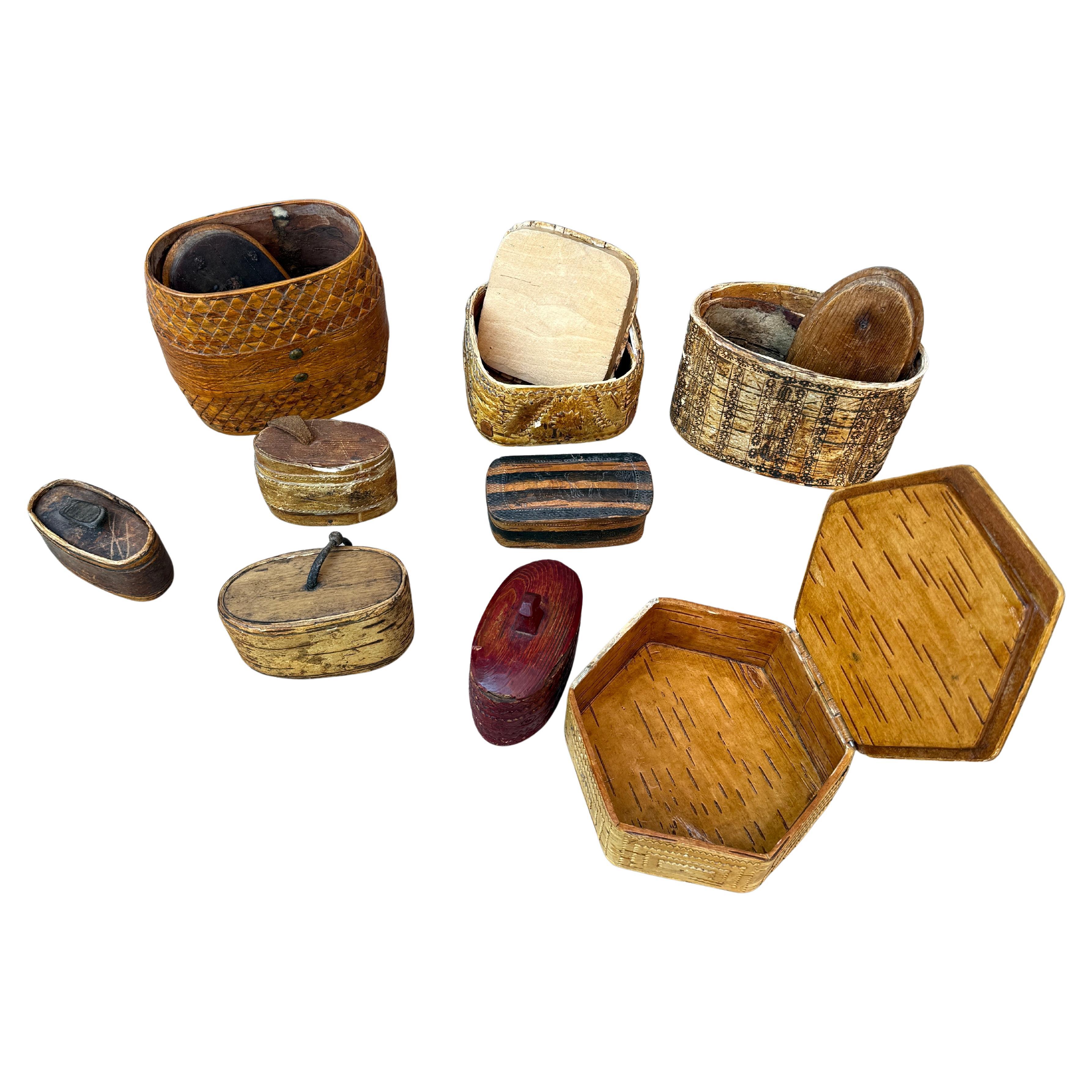 A collection of 9 Swedish carved small Folk Art boxes made in birch bark and pine wood from the Scandinavian country side. These 19th Century/Early 20th Century small collectibles were hand crafted and sometimes painted, used to keep personal small