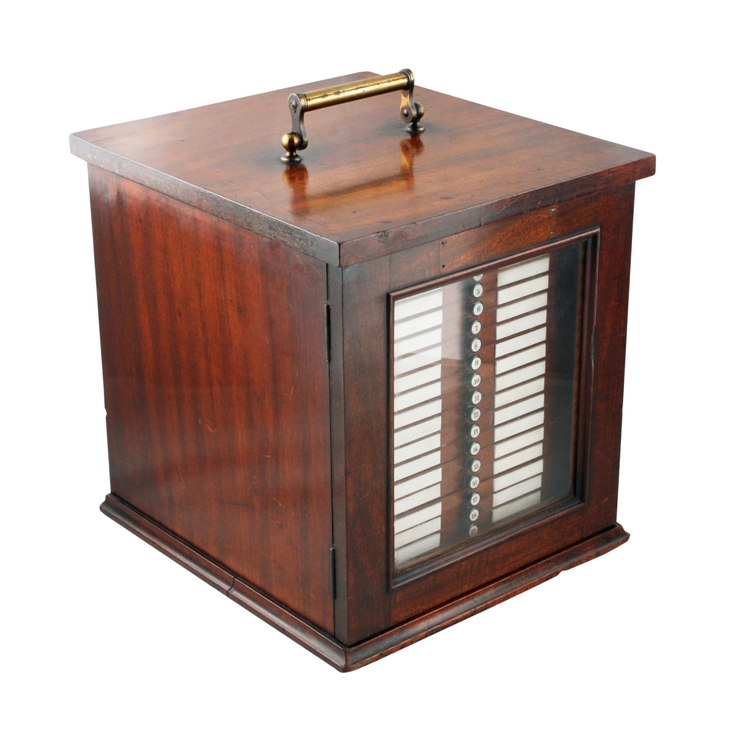 

19th Century Collector's Cabinet


A late 19th century Victorian mahogany collector's or specimen cabinet.

The cabinet has a gilt brass hinged carrying handle and a glazed locking door.

The interior holds twenty slim drawers with blue