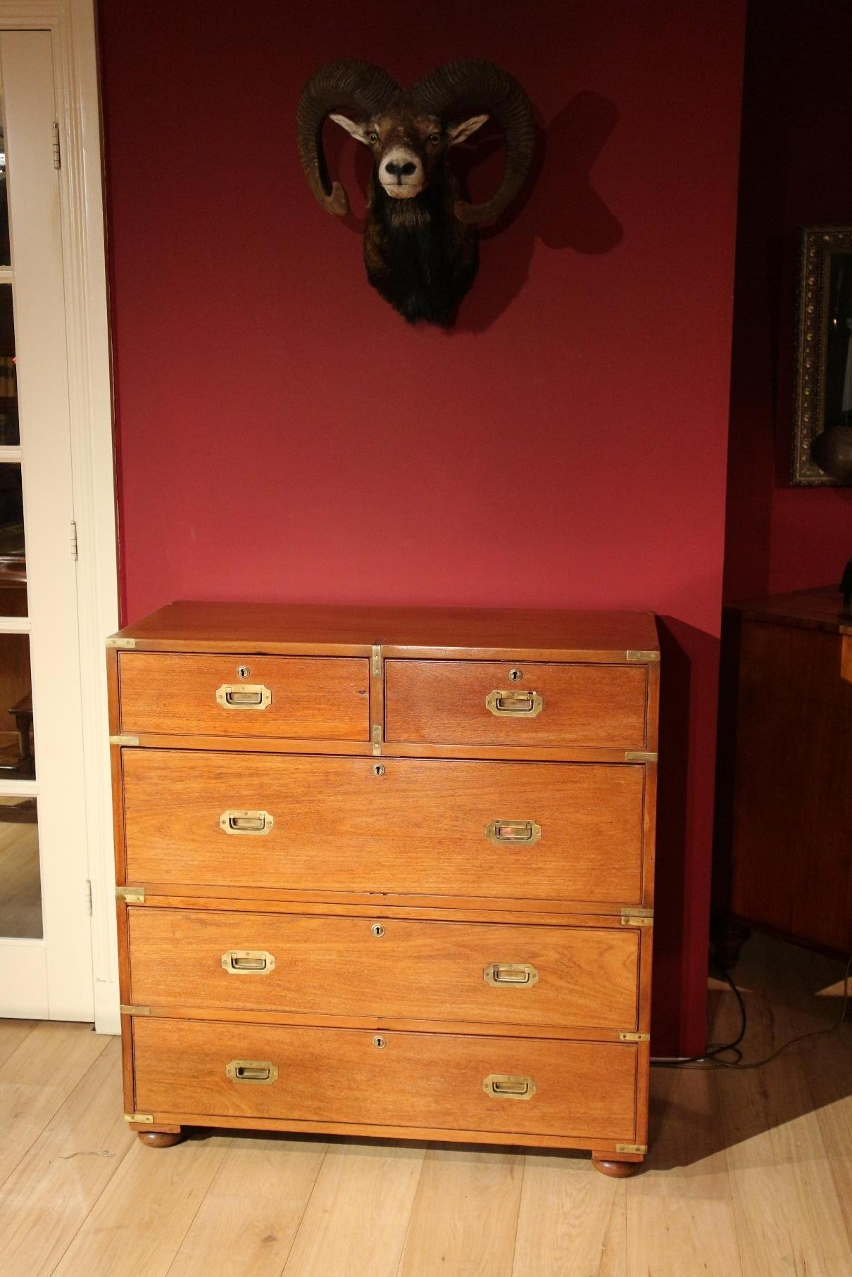 Beautiful sleek antique teak campaign chest of drawers from England, completely in perfect condition. Nice light color.

Origin: England

Period: Approx. 1840

Size: W 99 cm, D 45 cm, H 100 cm

These cabinets were taken by the officers of
