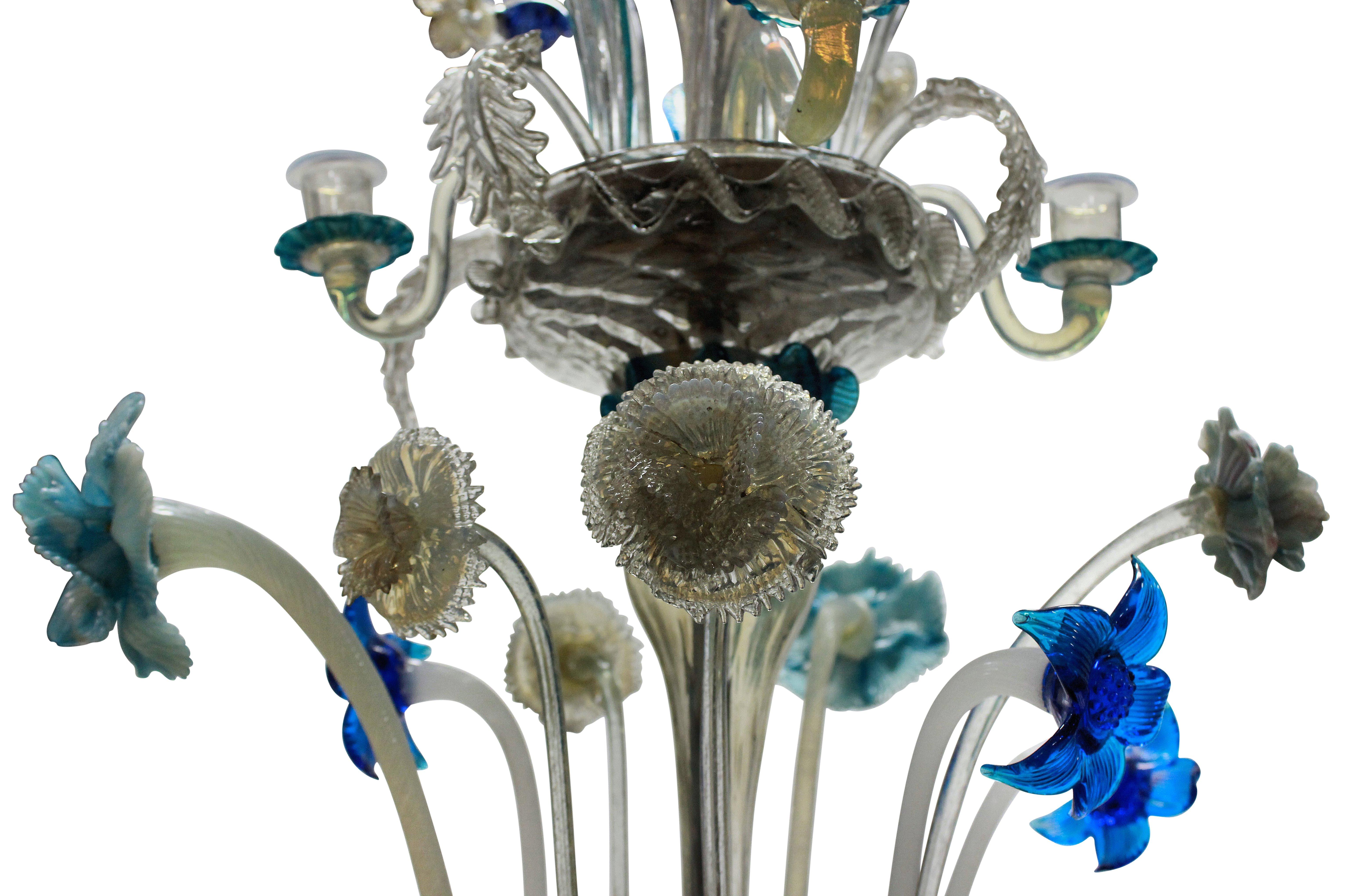 A pretty Murano glass chandelier in various shades of blue. Profusely decorated with hand blown glass flowers. There are historic repairs and nibbles to some flowers, typical of Murano chandeliers of this age.