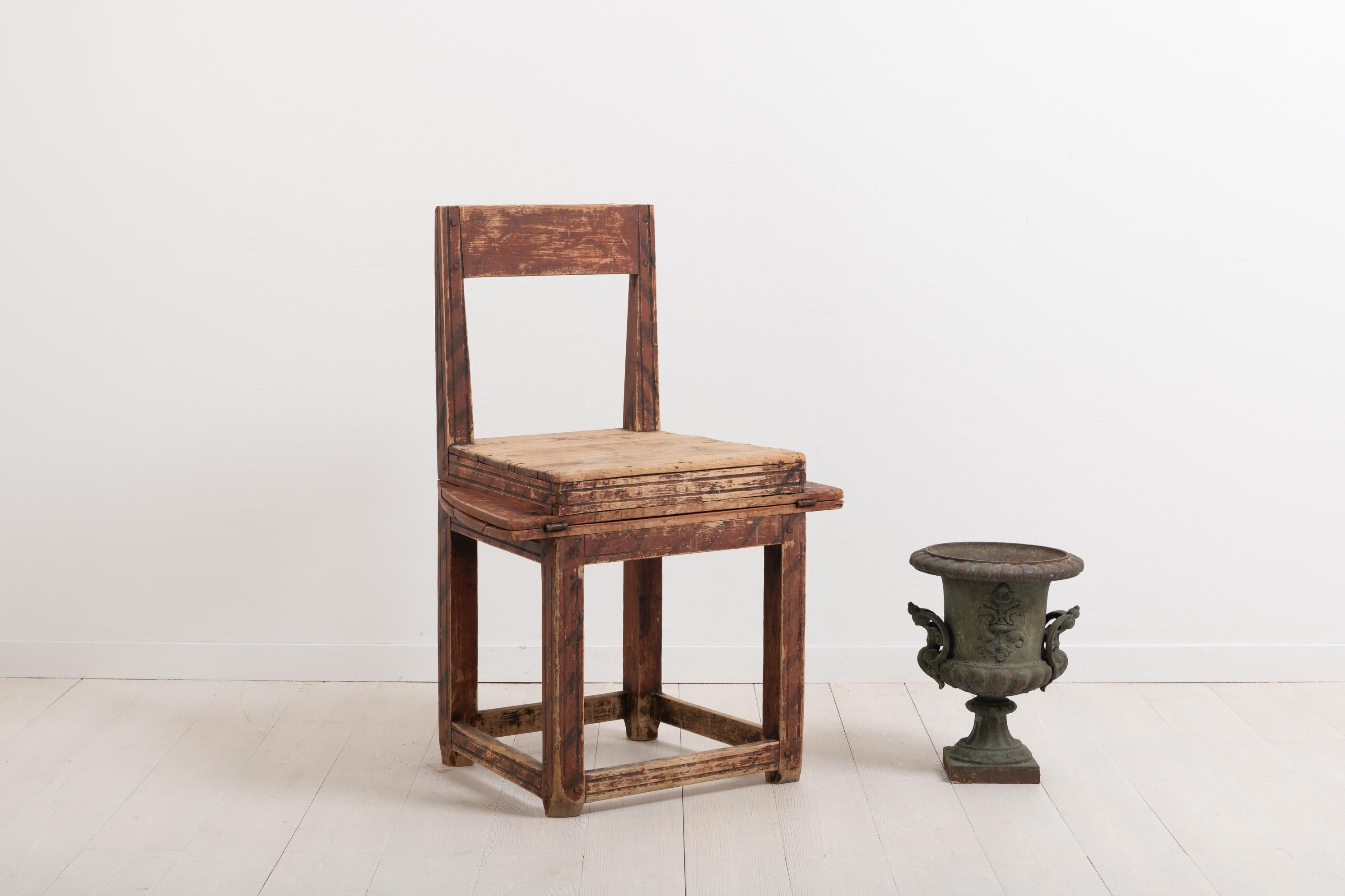 Primitive combined chair and table. This folk art combination furniture is a good example of 19th century compact living. The goal was to fit as many uses into the same item or a limited space, such as this combined chair and table. It is in