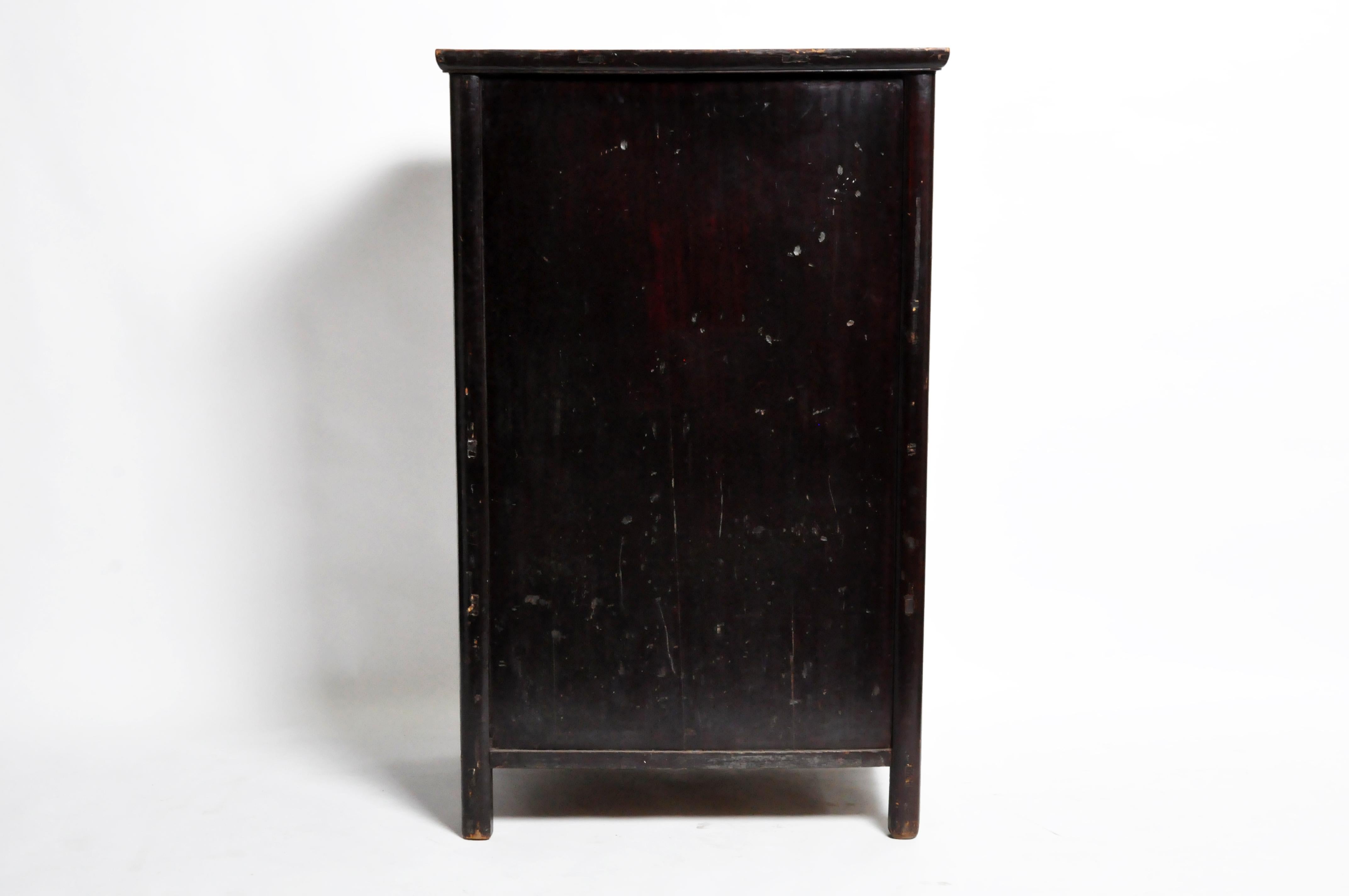 This compact armoire is comprised of beautiful clean lines; an asymmetrical overhanging top called a cabinet’s cap surmounts straight, convex legs and feet. A pair of doors, with moulded edges and metal lockplates, conceals a drawer-lined interior