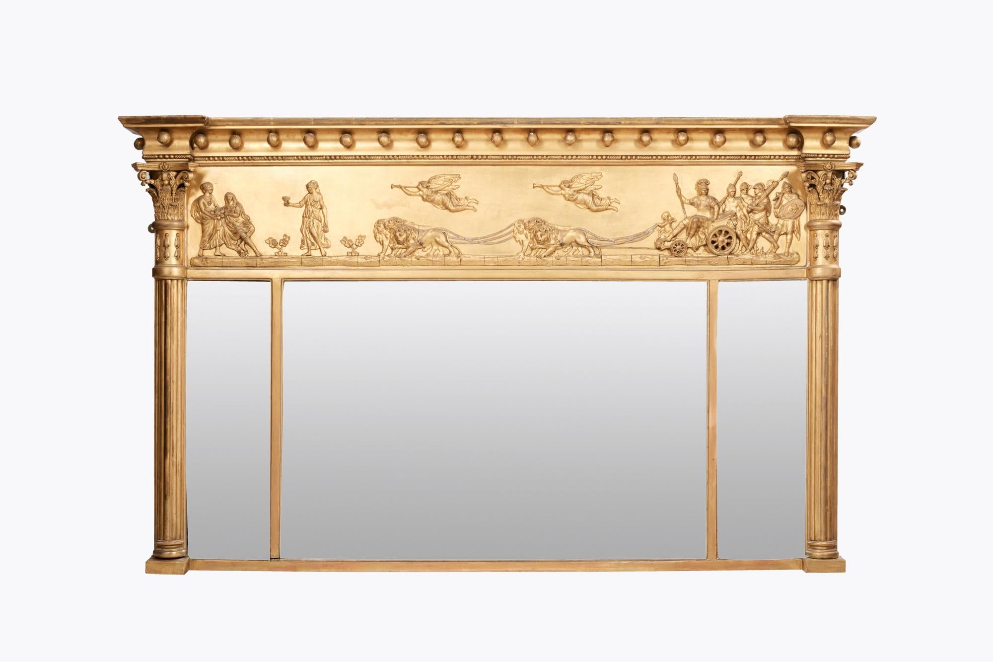 19th Century Regency giltwood overmantle mirror. The molded cornice and balls above ebonized classical frieze depicting Marc Anthony being pulled in a lion-drawn chariot, circa 1810.