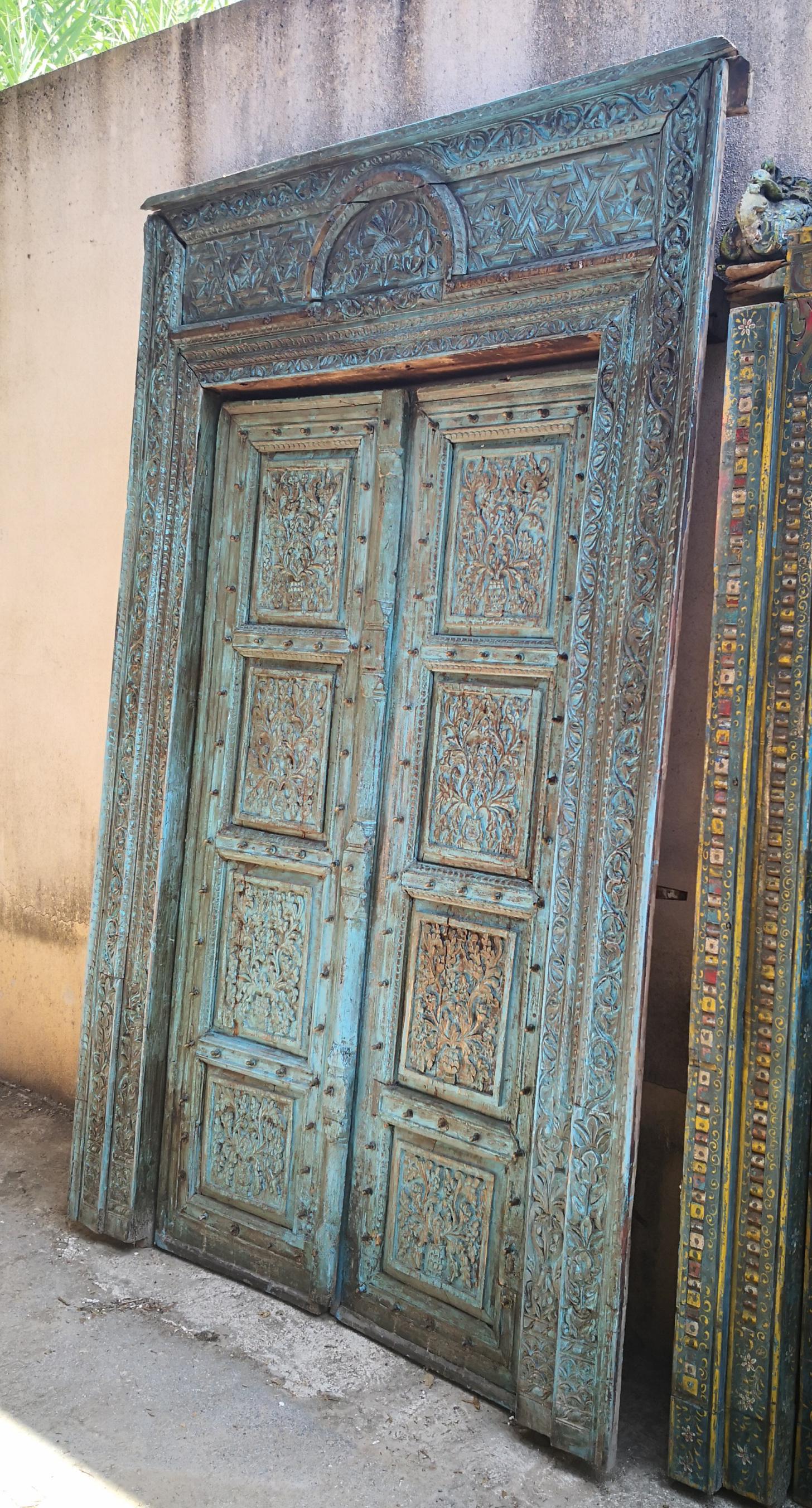 19th century complete Indian hand-carved wooden main door with original polychrome.