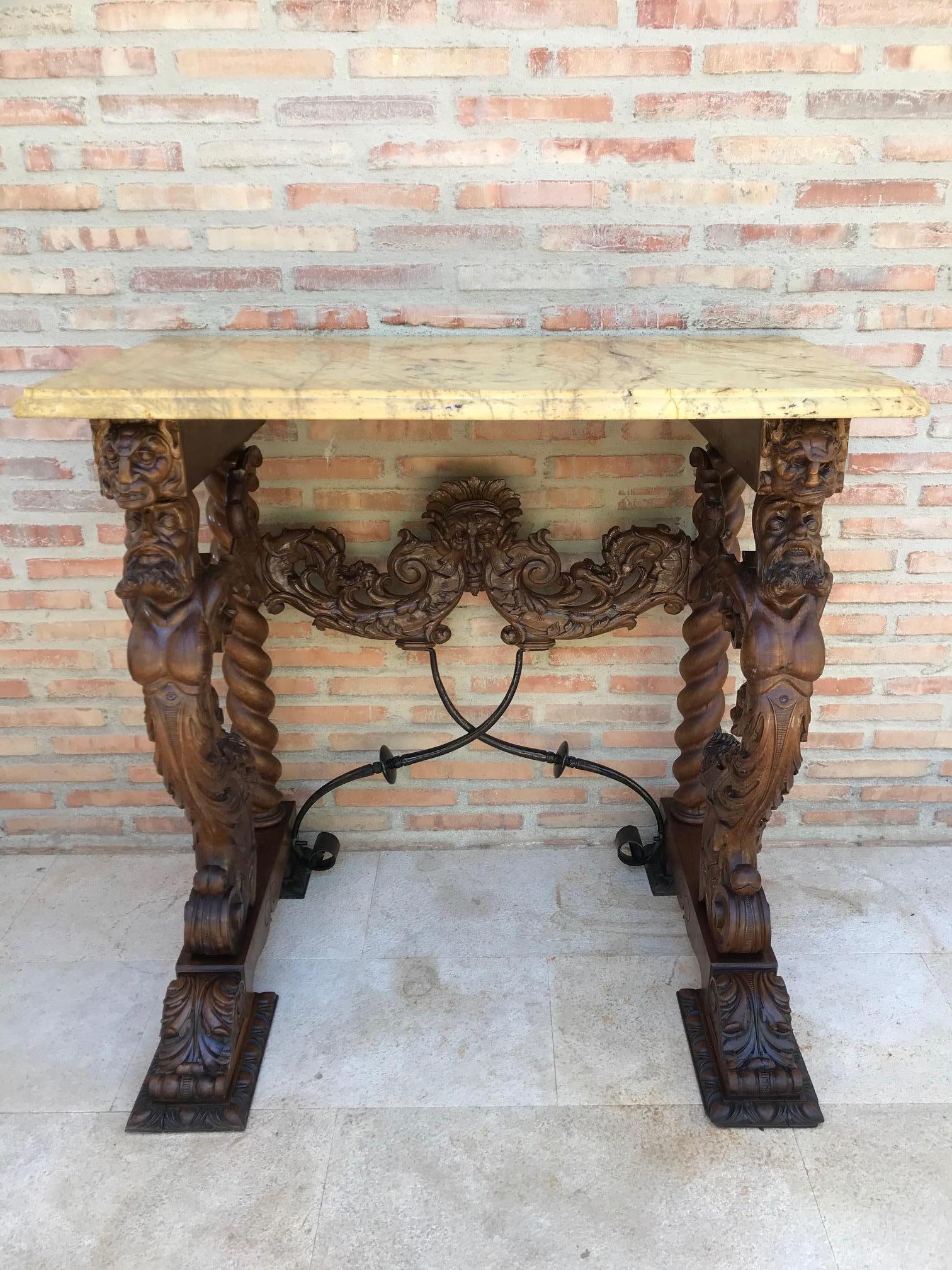19th century console carved table Renaissance with beige marble top. 
Made of solid walnut wood with beige marble top. 
It features carvings of mythological animals and plant motifs. 
Foot with turned rear columns and front columns in the form of