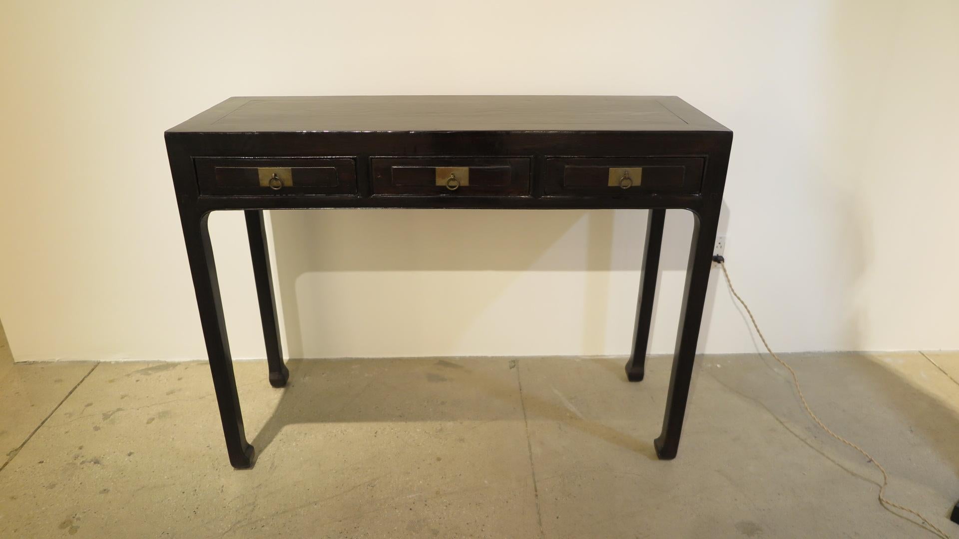 19th century Chinese console table. Three drawer thin console table elegant refined lines with ring pull handles. Detailed arch apron top of legs tapering to horse hoof feet. Very good condition commensurate with age and use. Please see pictures.
