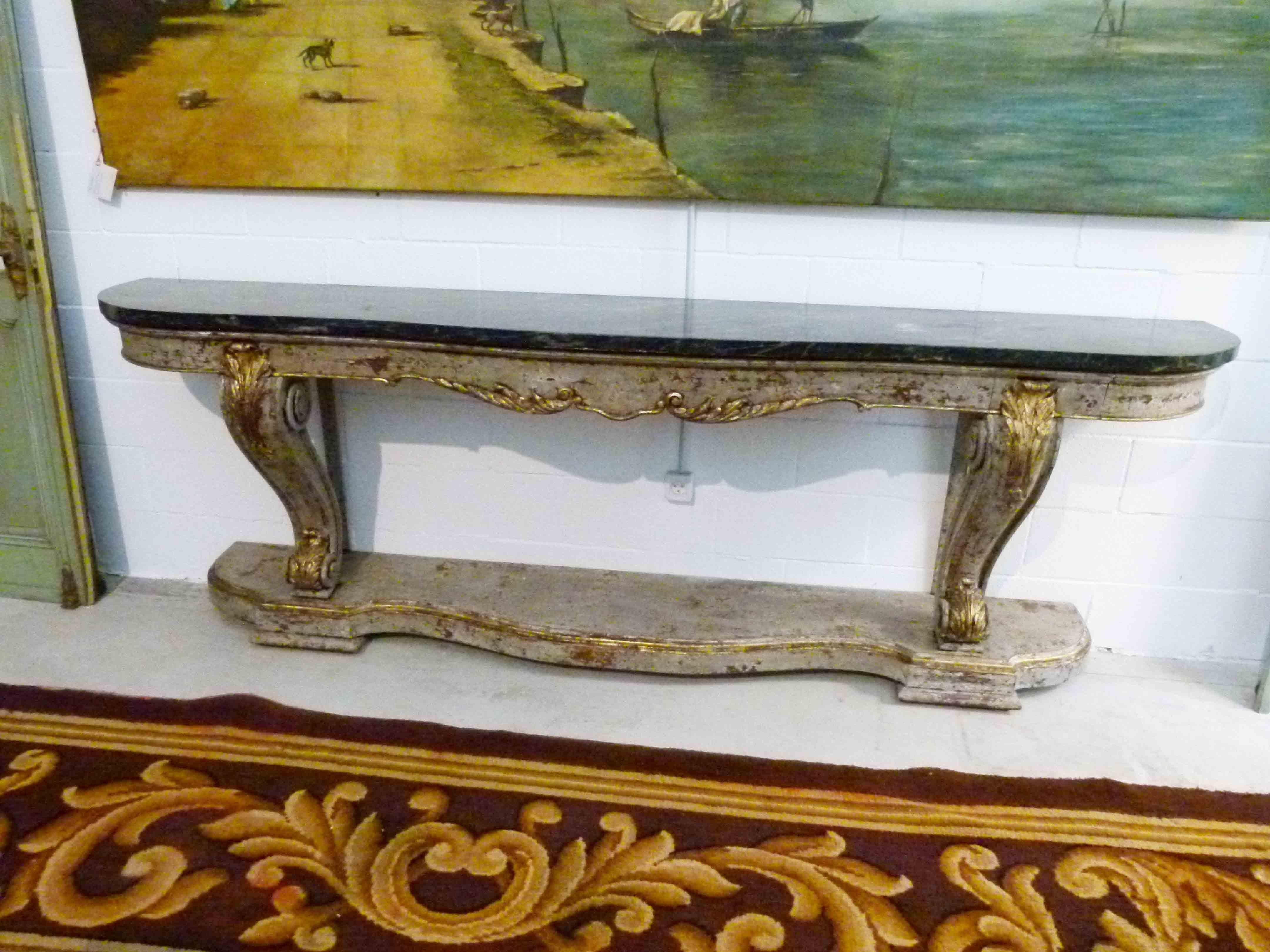 19th century console table with an oval shaped top marble in green color. Wooden hand carved base with patina.
A refined piece that will grand the room.


 