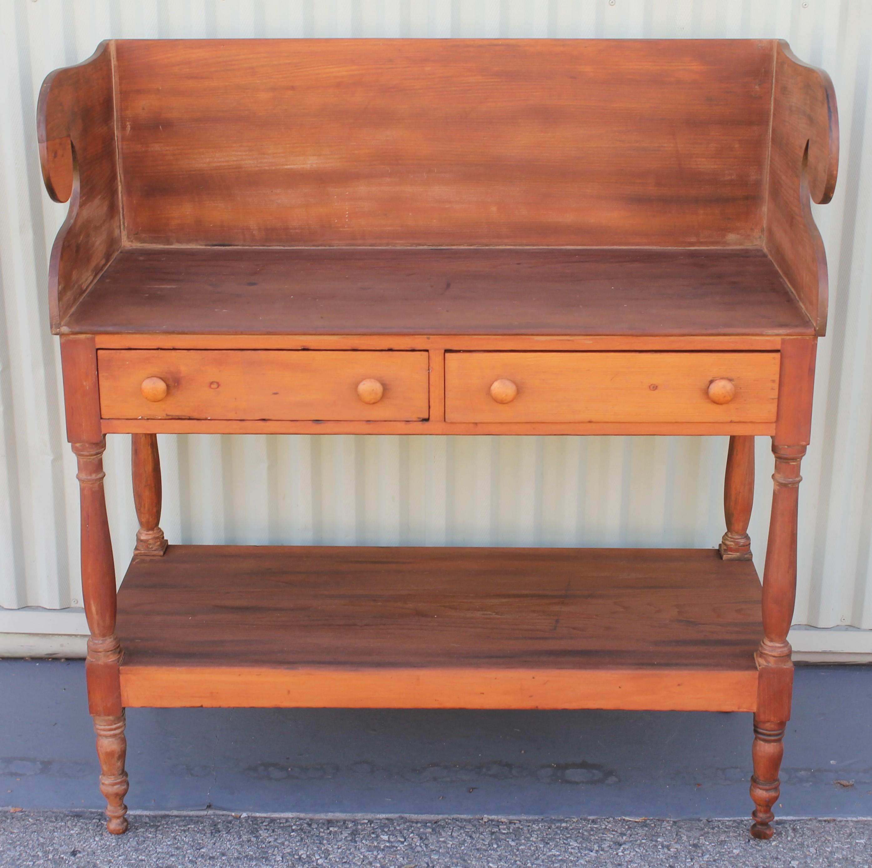 This fine and early side table has wonderful cut-out and dovetailed case and drawers. Fantastic form and condition. Great side table or serving table in a dining room.