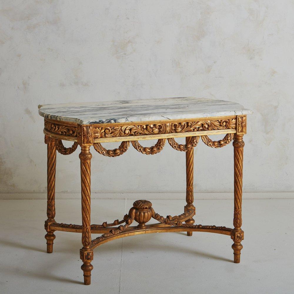 This 19th century gilt wood console table is an excellent example of the Louis XVI revival and would have been prominently displayed in an entrance hall or salon in the late 1800s of a large French home.

Featuring stellar craftsmanship as seen in