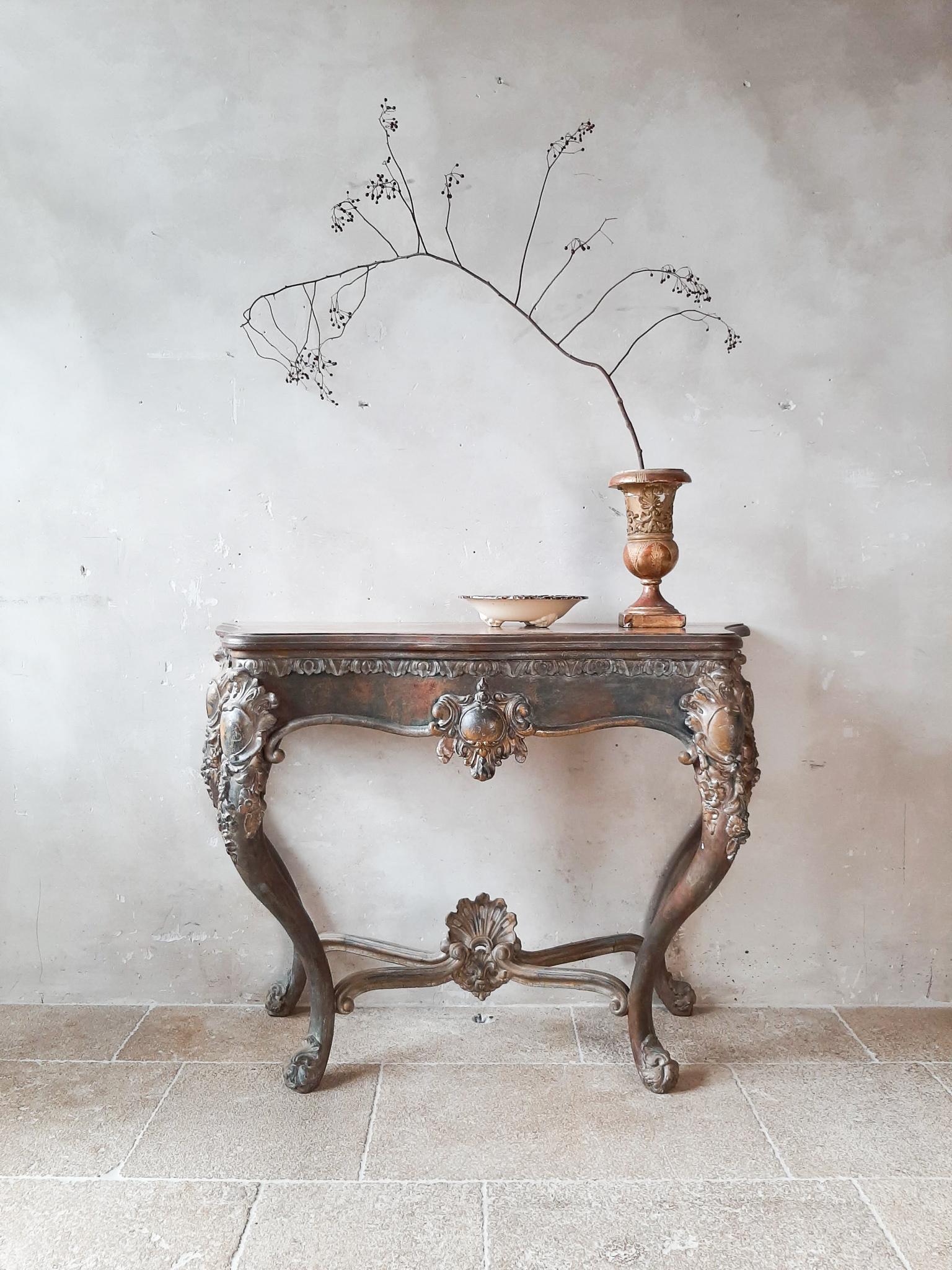 Antique console table with special patina in gold / cognac tones mixed with petrol colors. Neo-classic style, late 19th century.

Measures: height 90 cm x width 121 cm x depth 53 cm.