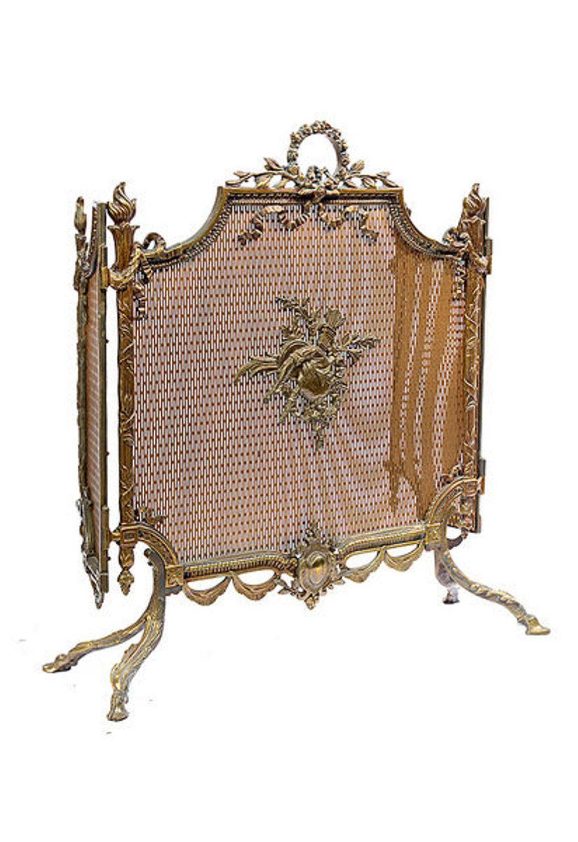 A continental brass folding fire screen, the three sections each with thick brass mesh backing and decorative brass mounts.

The center panel with a carrying handle to the top, the outer sections hinged.

The whole raised on on four out swept