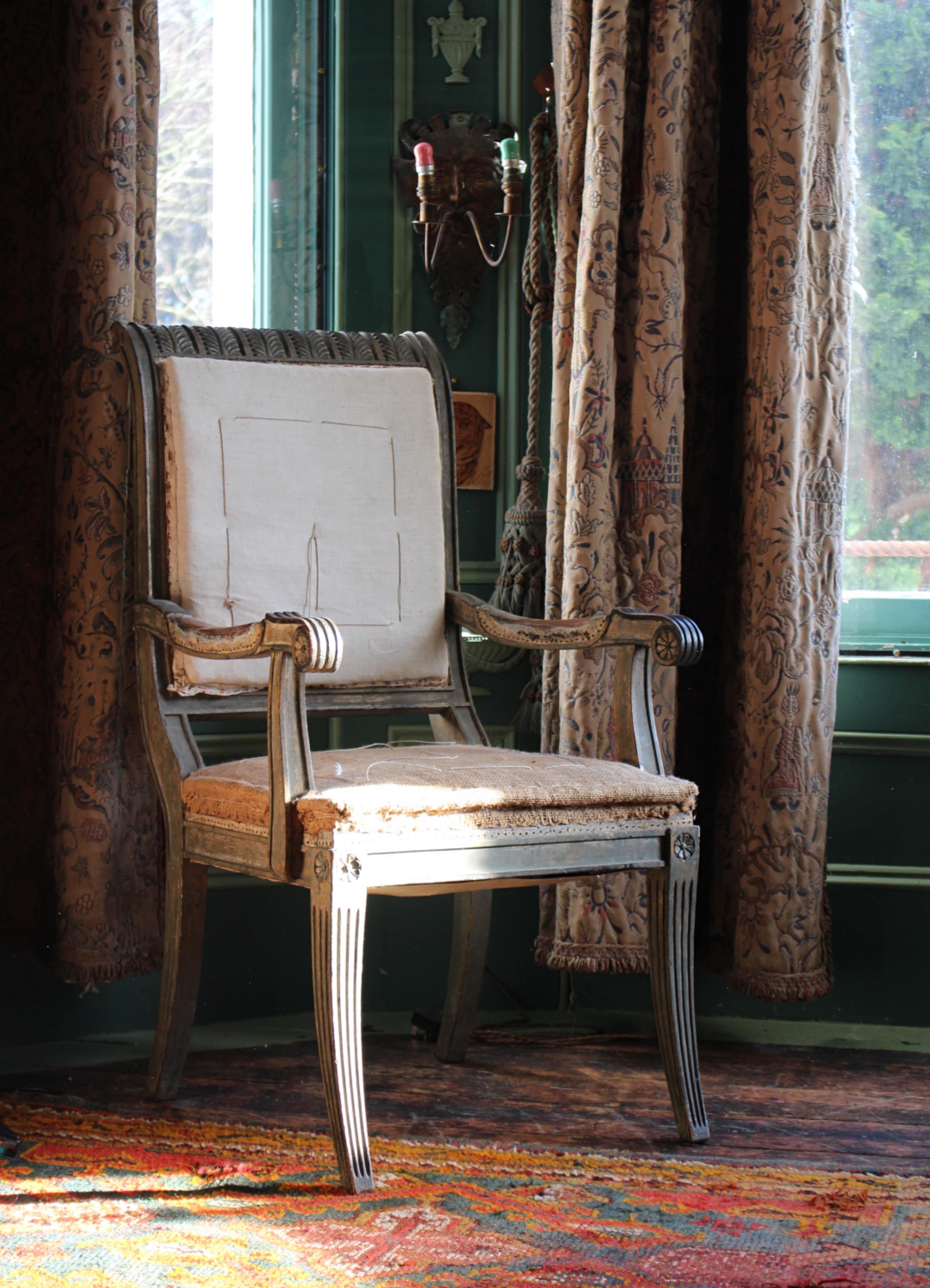 A wonderful shapely armchair, with remnants of its original mist green painted finish and gilt decoration. 

Solid and perfectly fit for purpose, ready for upholstery if desired or works beautifully as is. 

19th century in age, European in origins.