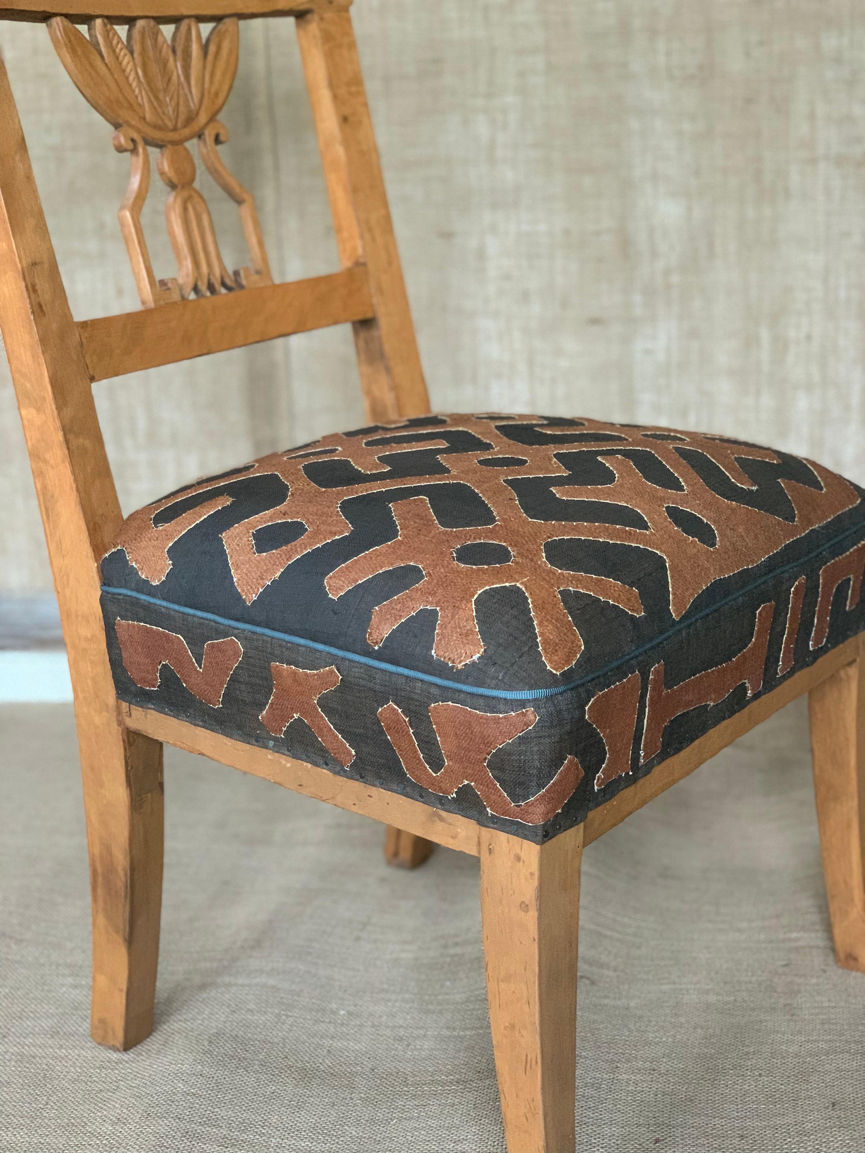 19th century continental diminutive side chair in Fruitwood, upholstered seat cushion in vintage African Kuba Cloth.