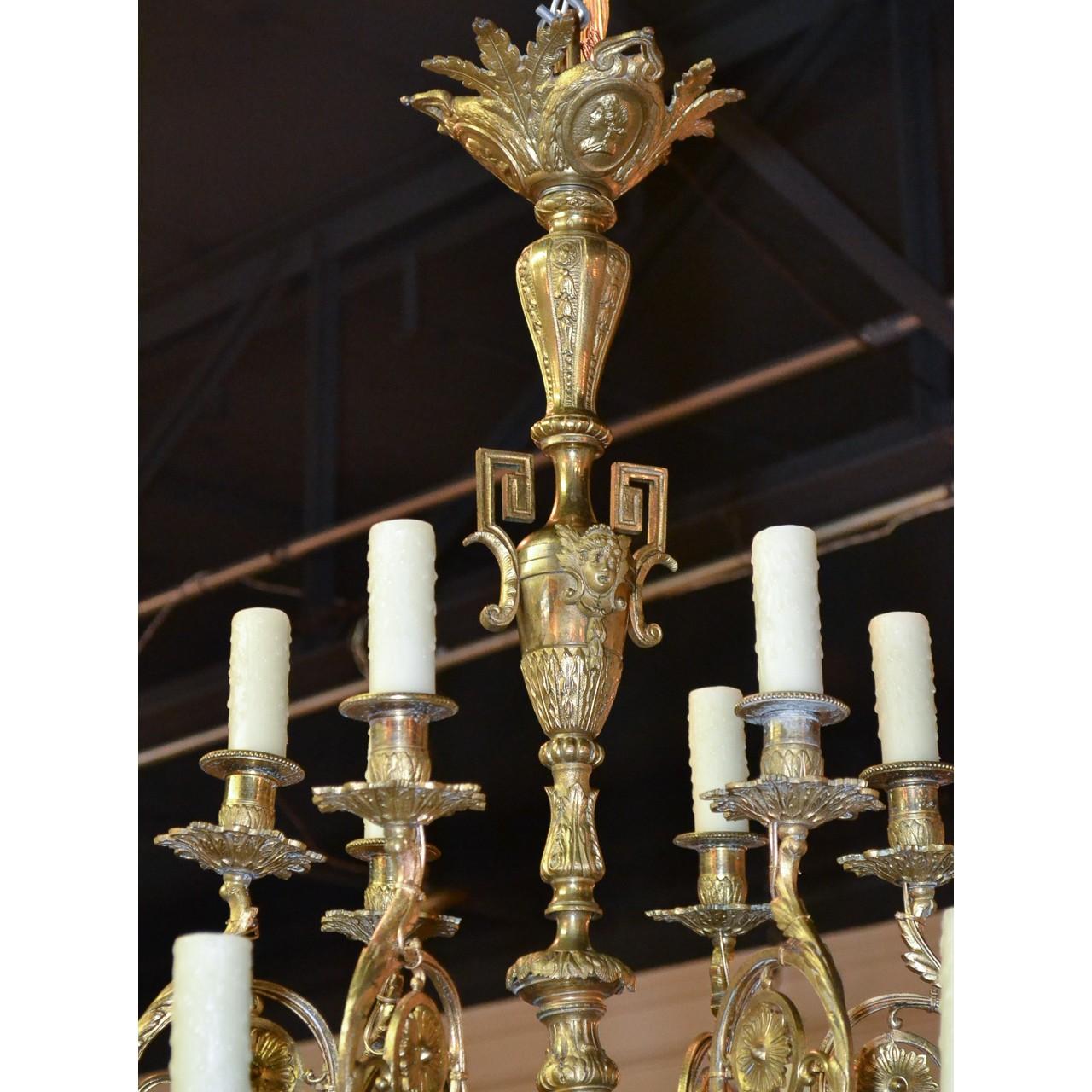 Remarkable 19th century Continental gilt bronze chandelier with a leaf-spray crown decorated with embossed portraits panels. The shaped, tapered, and urn-fashioned stem with cherub busts and Greek key styled surmounts. The elaborately scrolled