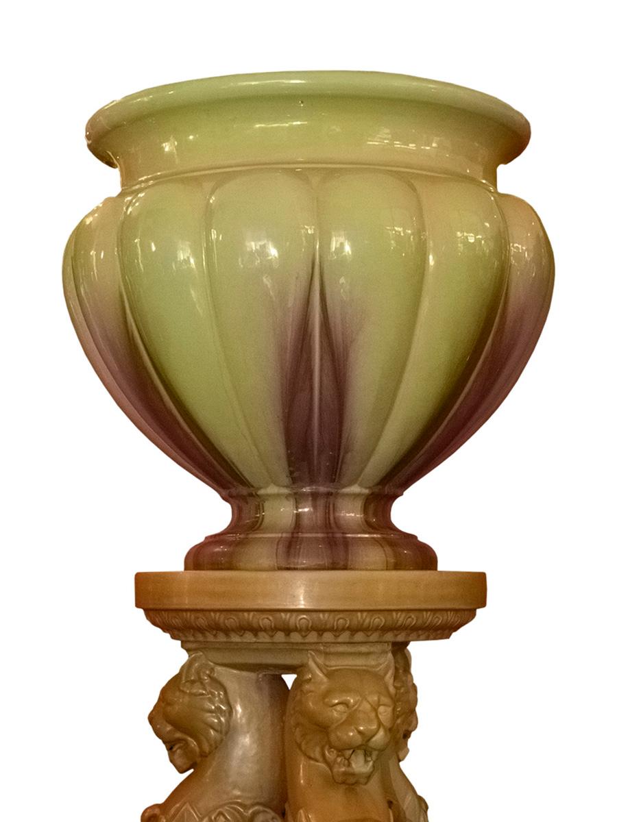Continental Majolica vase from the 19th century, made in molded green enamel. Features three lion-shaped legs.