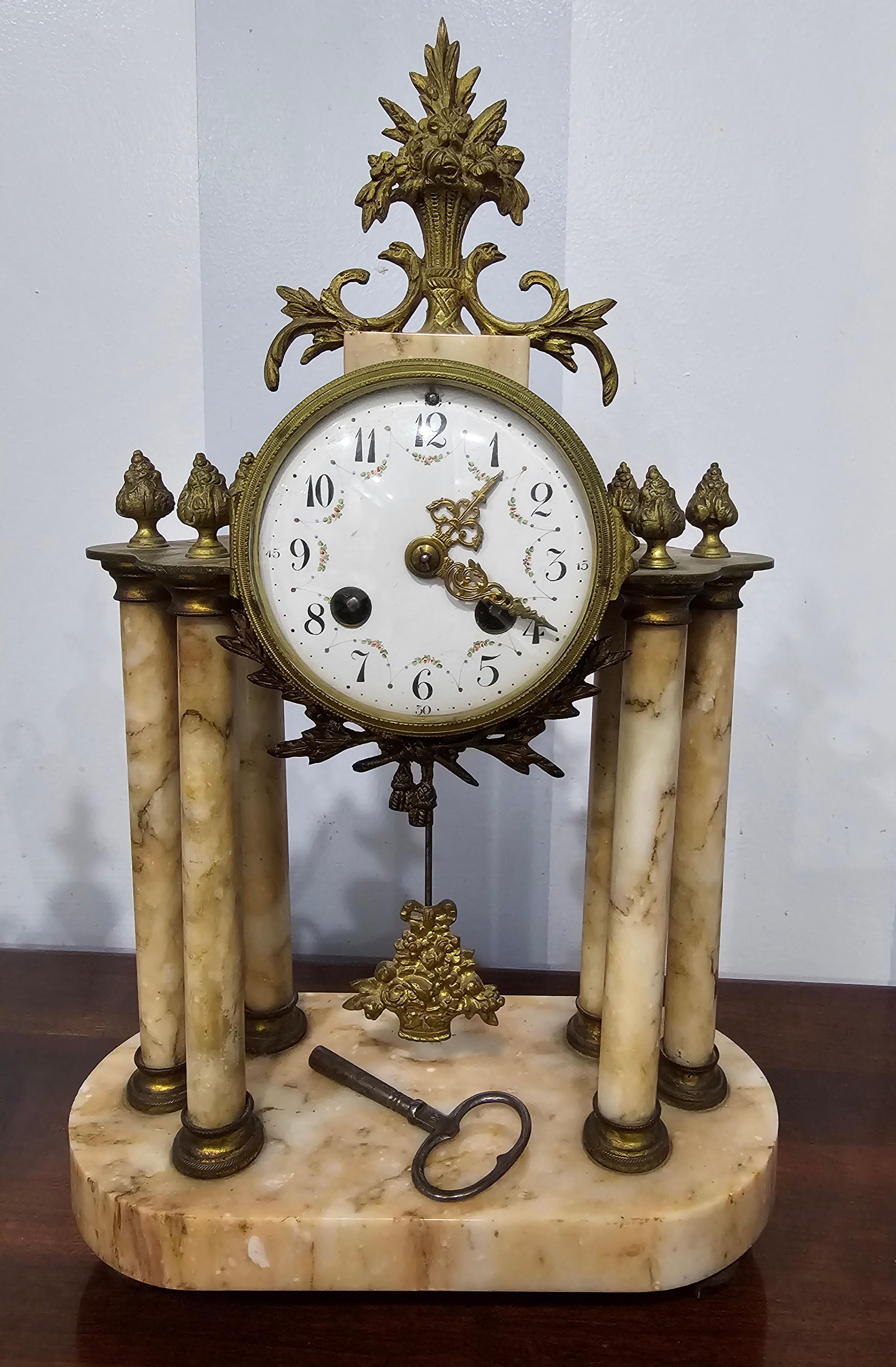 A monumental 19th Century Continental Neoclassical Style Brass and Marble Clock Garniture Set with working mantle clock and two marble and brass urns. Clock measures 10