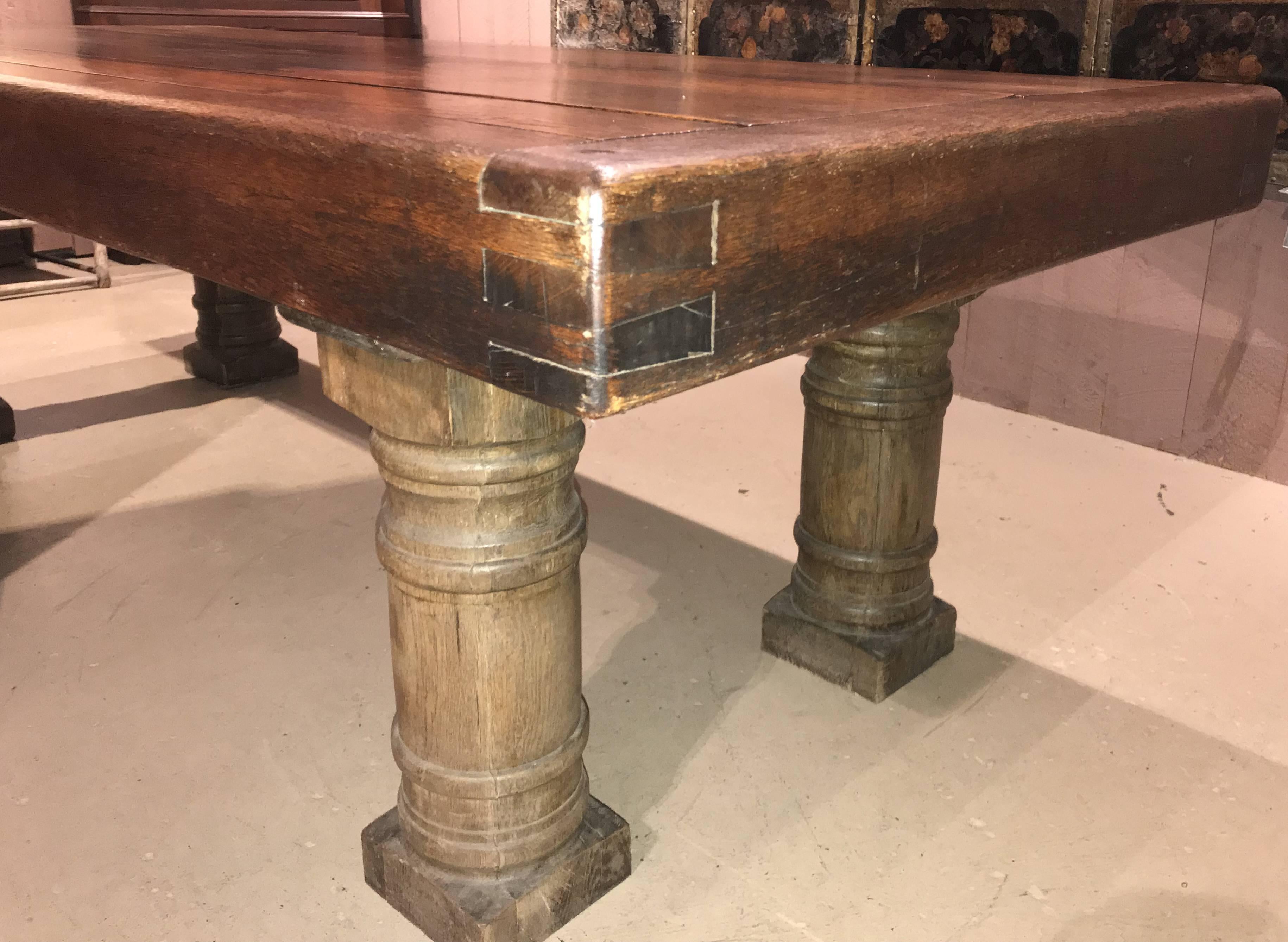 A solid two part oak refectory table with boldly turned legs and top with jointed and pinned corners. Continental in origin, dating to the 19th century. Very good overall condition with great patina, and a few shrinkage cracks running the length of