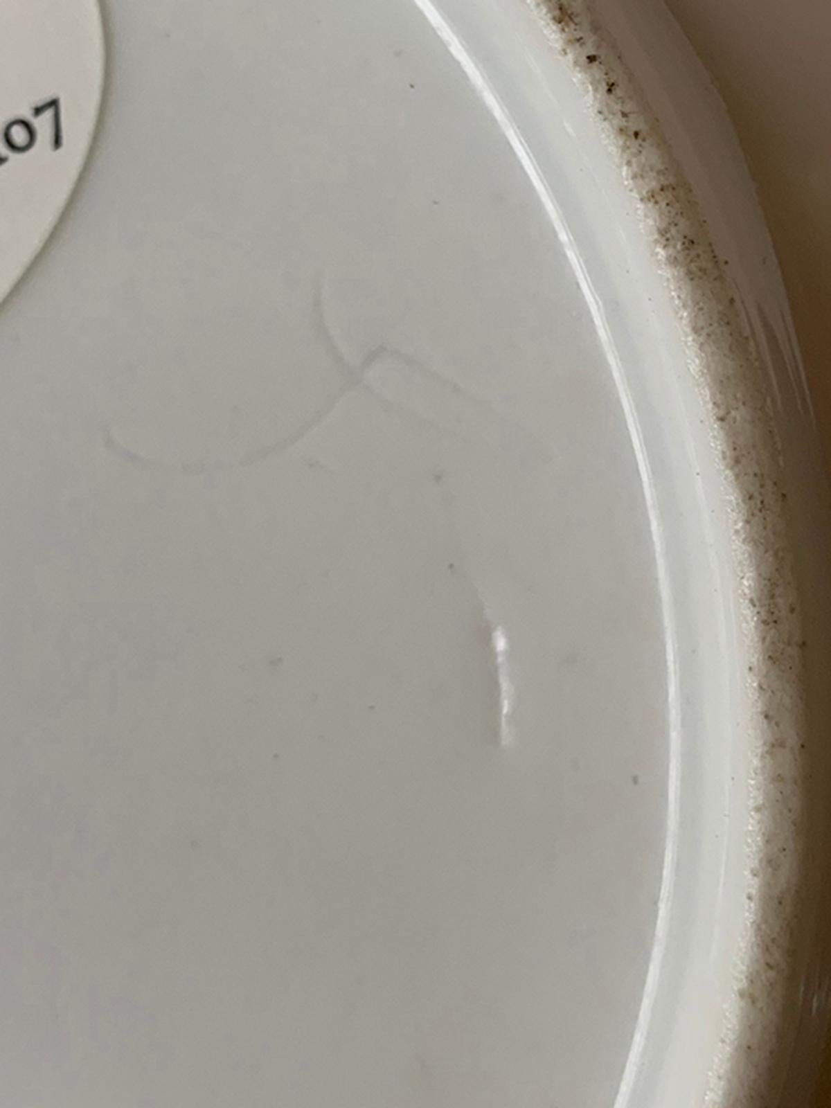 19th century continental round porcelain plate with gilt details and bordering, faint X-impressed mark. Unidentified mark.