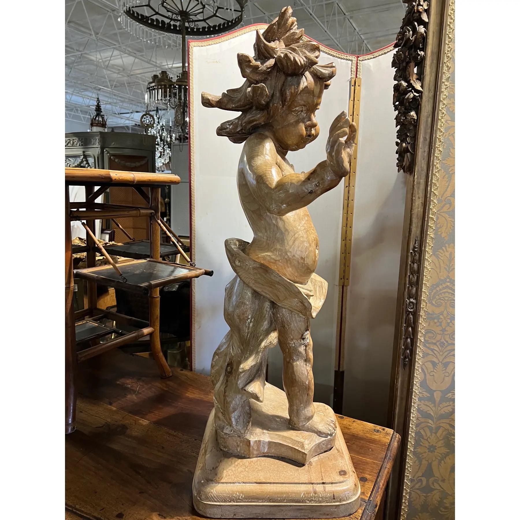 A 19th Century continental carved wooden putti. The Italian word putti refers to winged angel children, or more rarely boy toddlers or children.