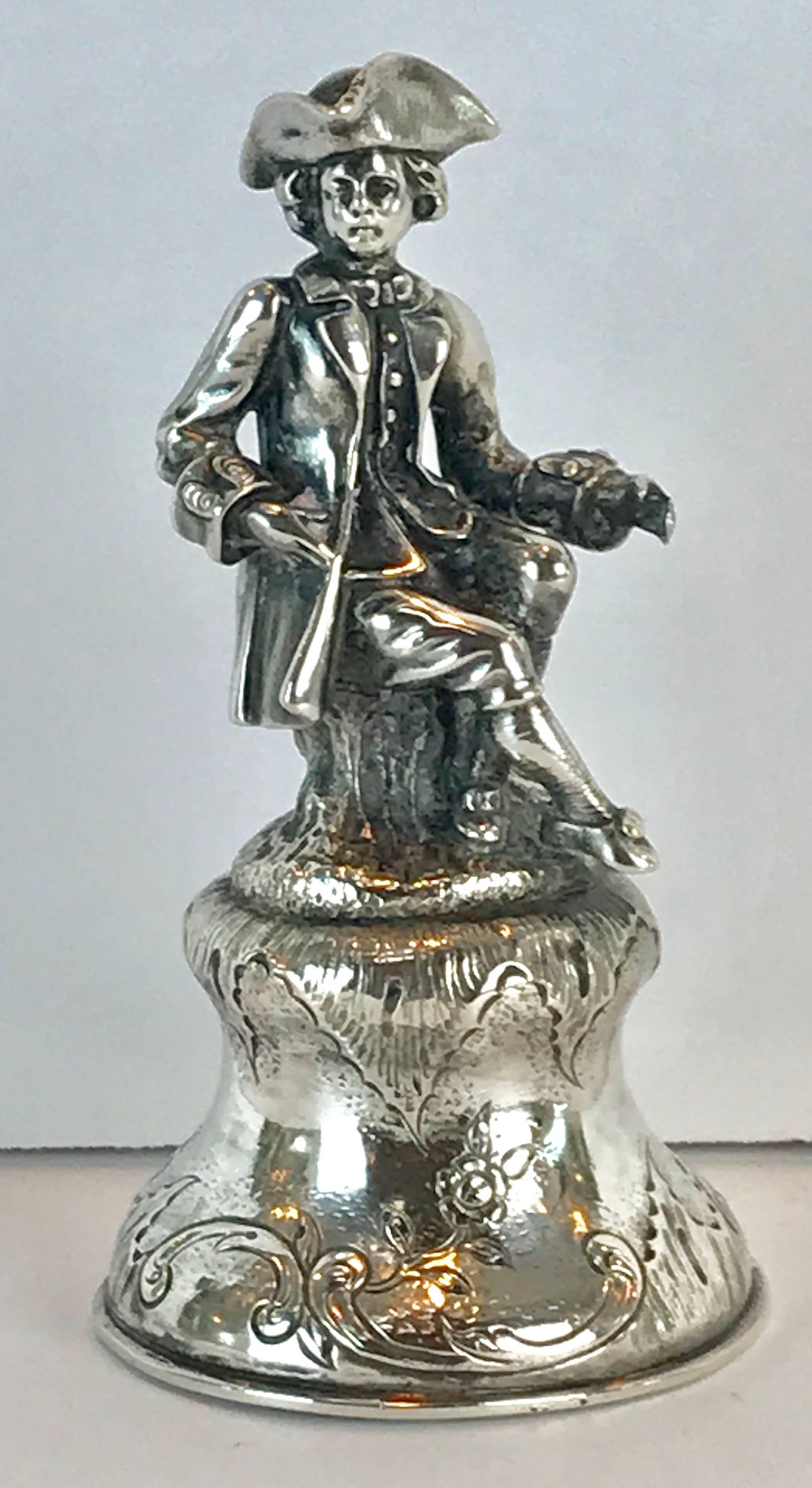 19th century continental silver figural bell, of a seated man in 18th century dress.