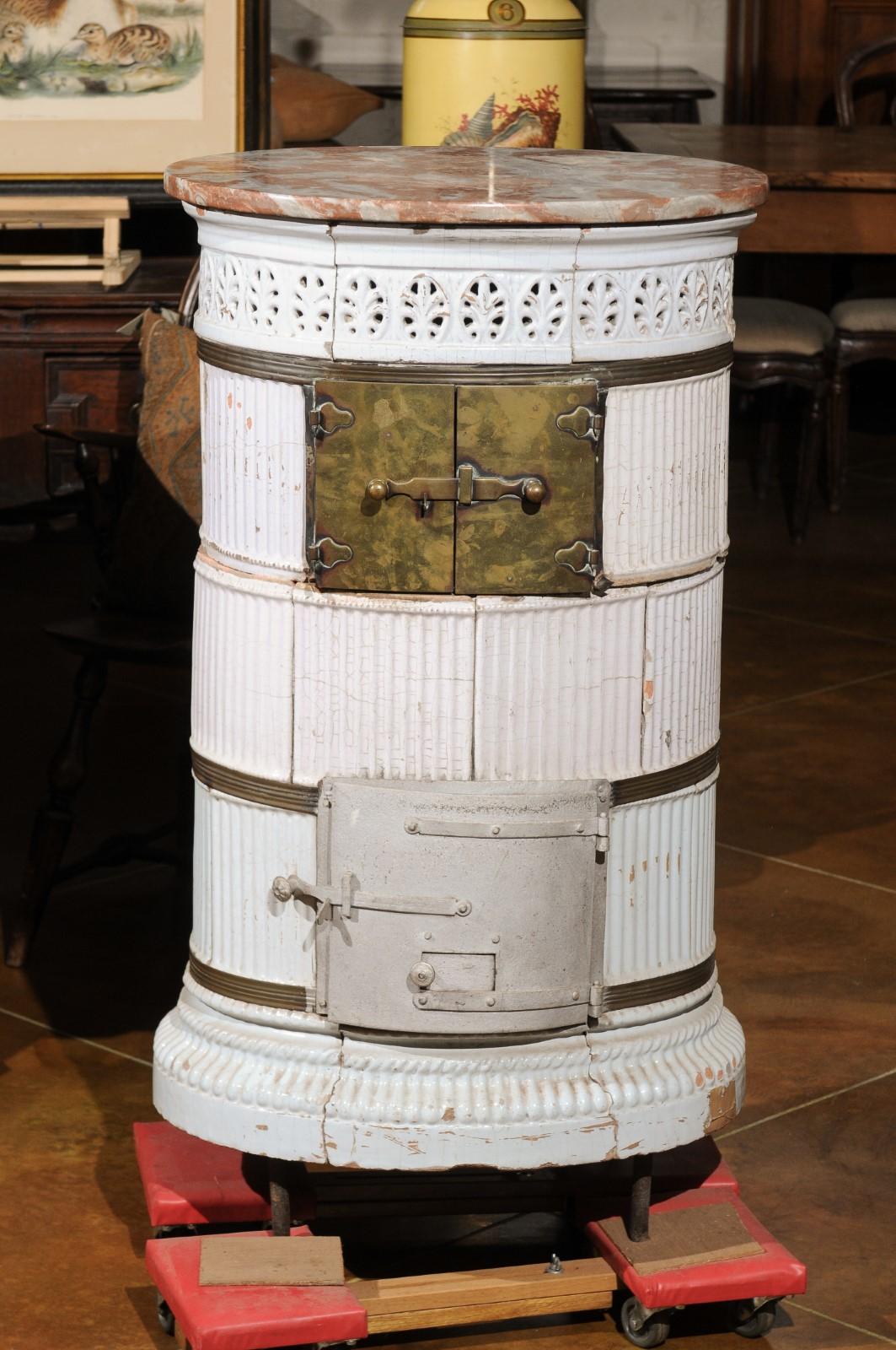 19th century continental white glazed ceramic coal burner with marble top.