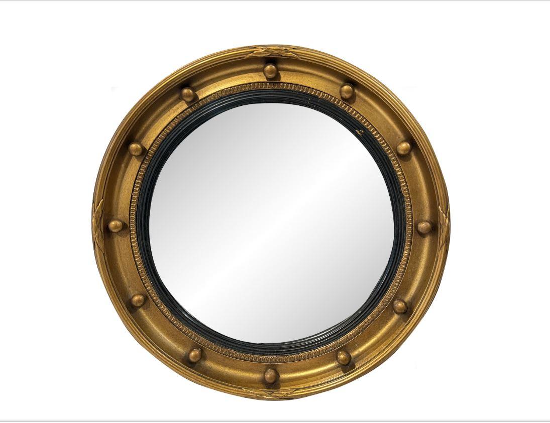 This is a wonderful little vintage convex mirror with the traditional reeding round the perimeter along with cross bows, and 12 ornamental spheres. The ebonized inner band adds the perfect accent, making the gold reeding show well. Mirrors like
