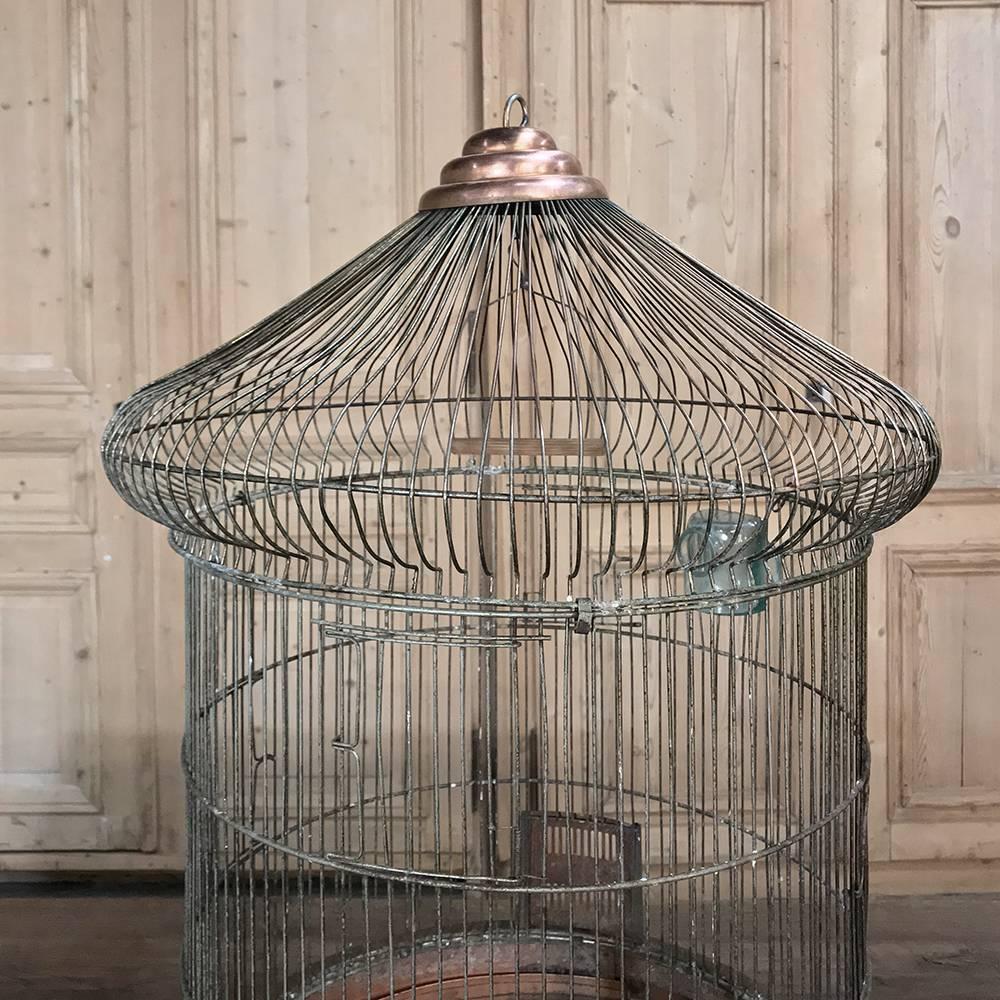 19th century  French copper and steel wire birdcage features a cuppola design and an abundance of Old World charm that will help you create a charming display for the room,
circa 1870’s
Measures 30 height x 18.5 in diameter.