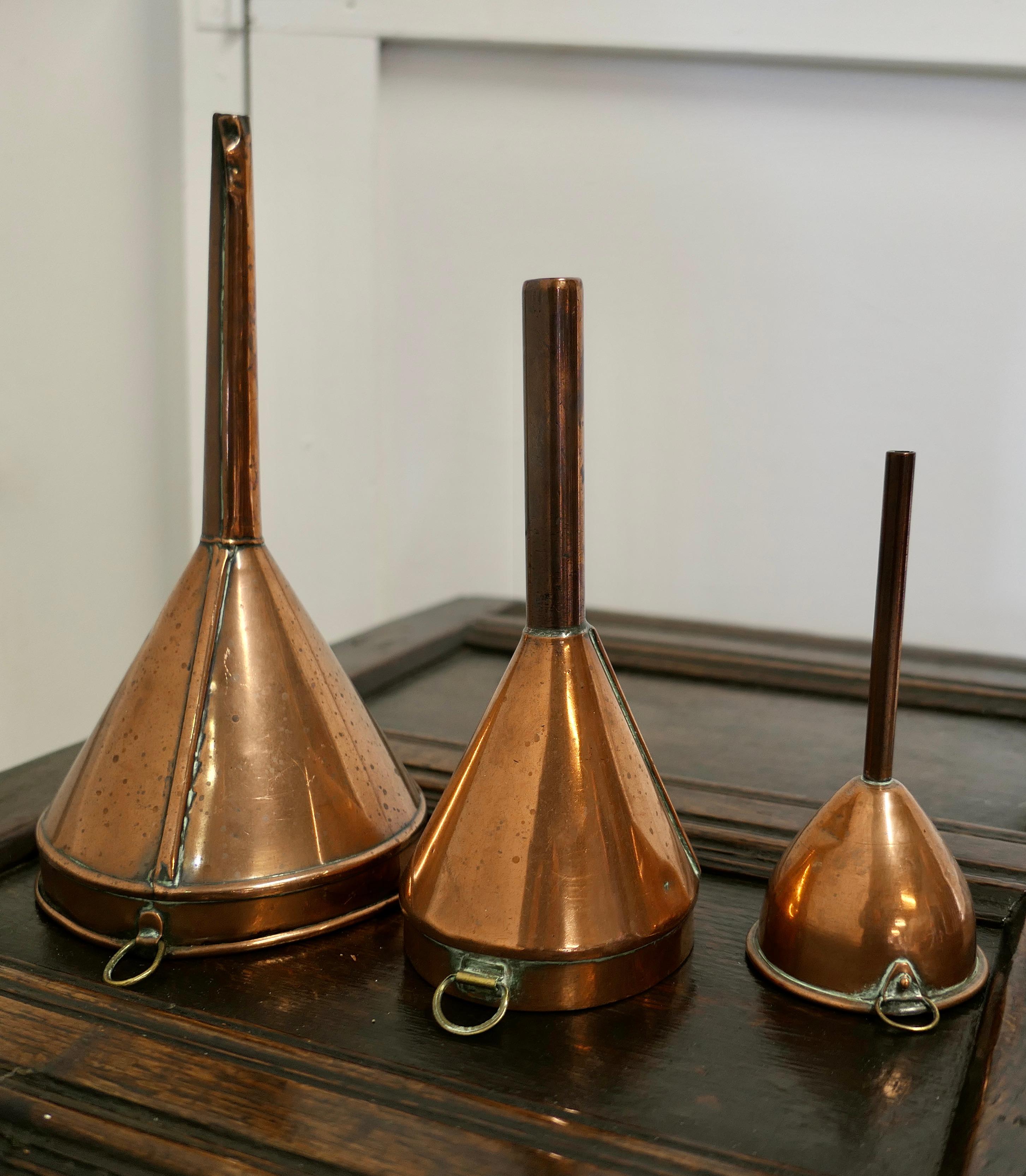 19th century copper Ale and wine funnel set

A Good Trio, the Ale and Wine Funnels are all in good used condition for their age, a handsome, decorative and useful set all with rings to hang them from
The largest funnel is 12”x 6” diameter
GF124.